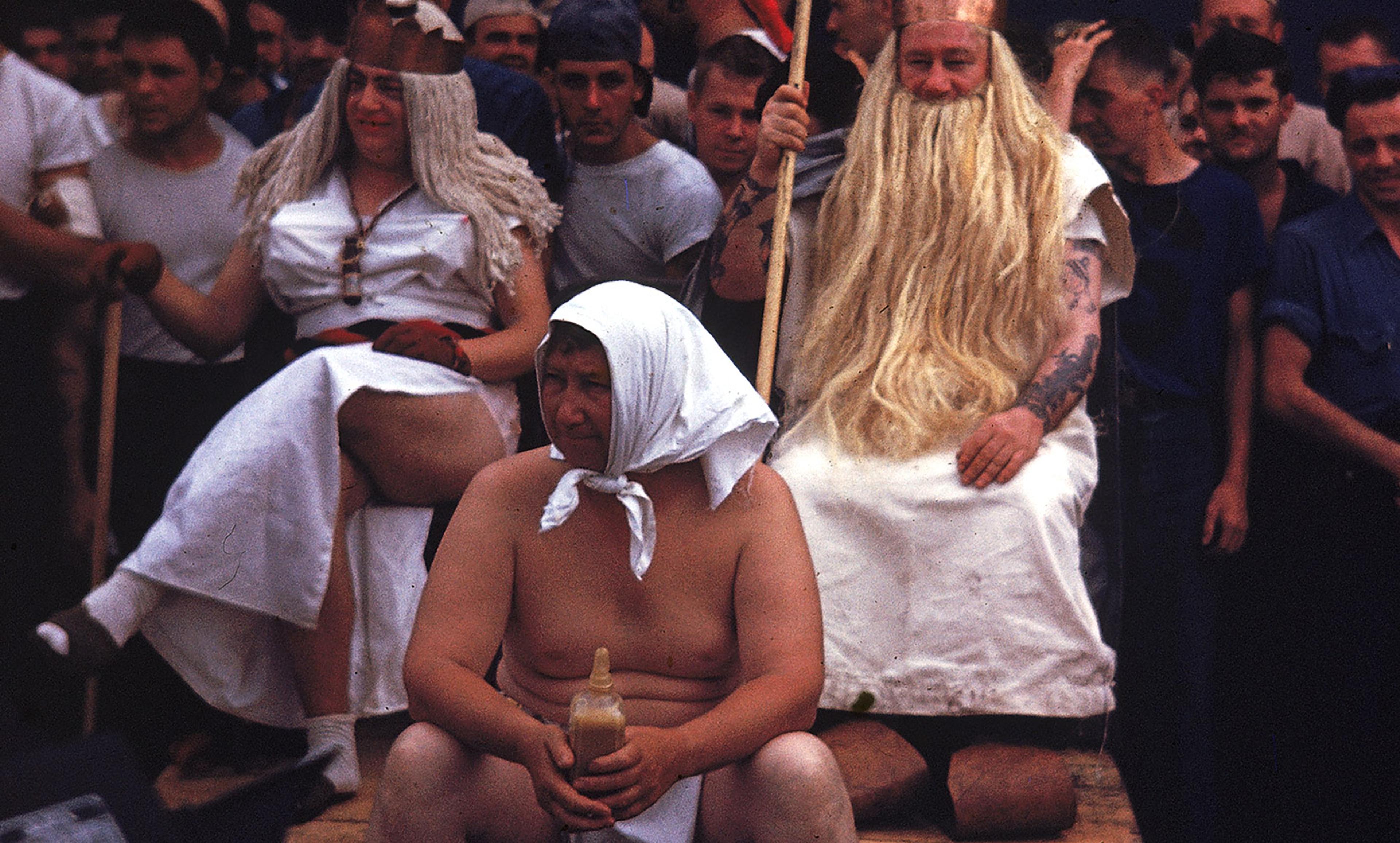 <p>Sailors aboard the USS Lexington celebrate crossing the equator with an elaborate hazing ritual, 5 April 1944. Participants include Her Highness Amphitrite (seated left), King Neptune (seated right, with trident), and a Royal Baby, all characters who ‘preside’ over the initiation.</p>
<p><em>Photo by J R Eyerman/LIFE/Getty</em></p>