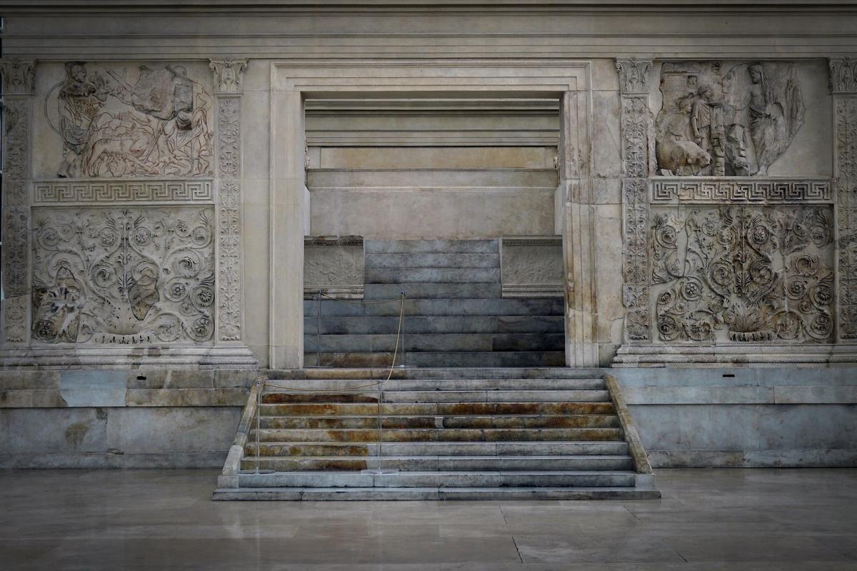 Photo of an ancient marble altar with intricate carvings and steps, showcasing classical architectural details and patterns.