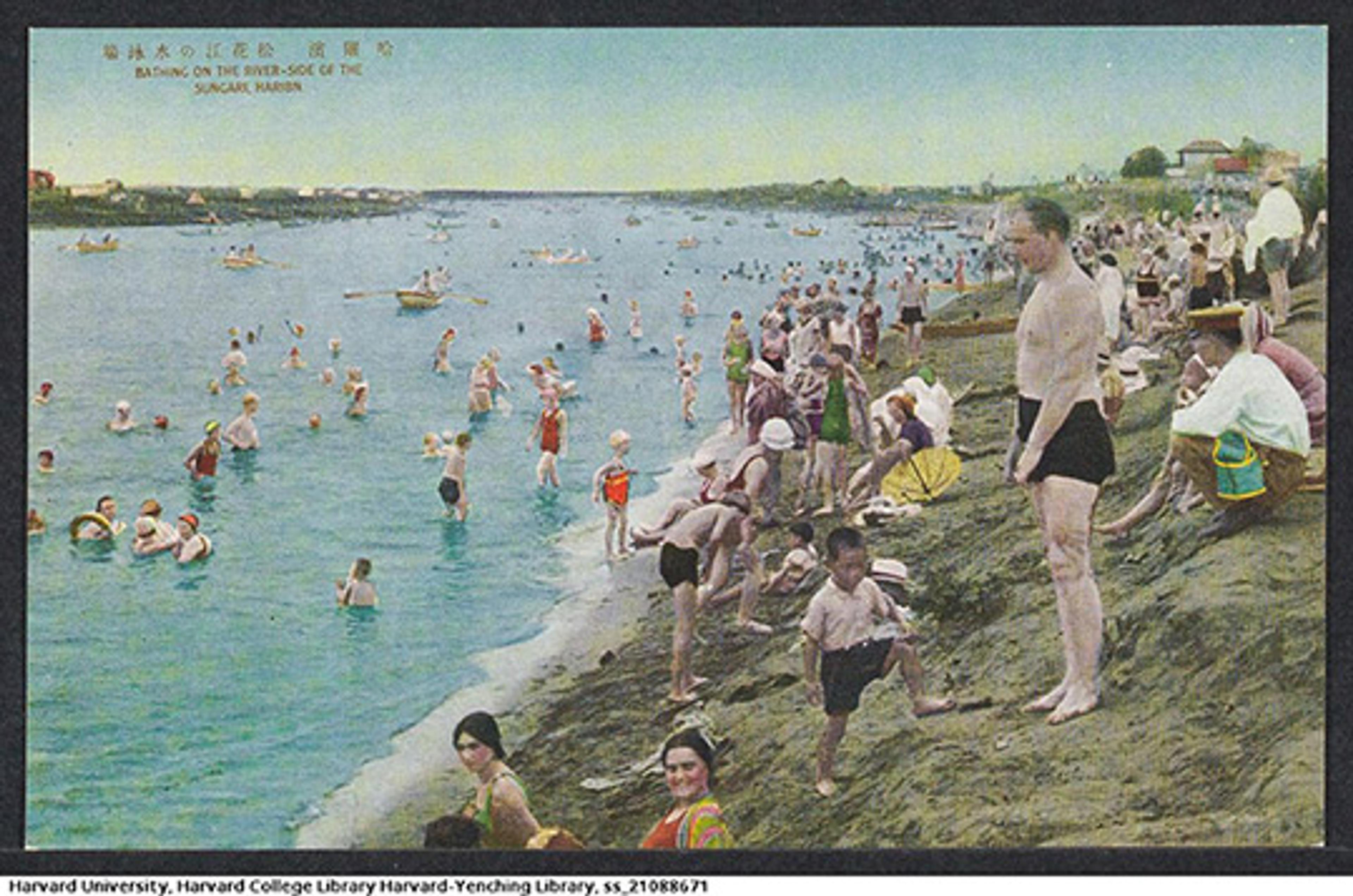 Vintage photo of people in swimsuits bathing and relaxing on the grassy banks of a river, with boats in the water, labelled “Shanghai”.
