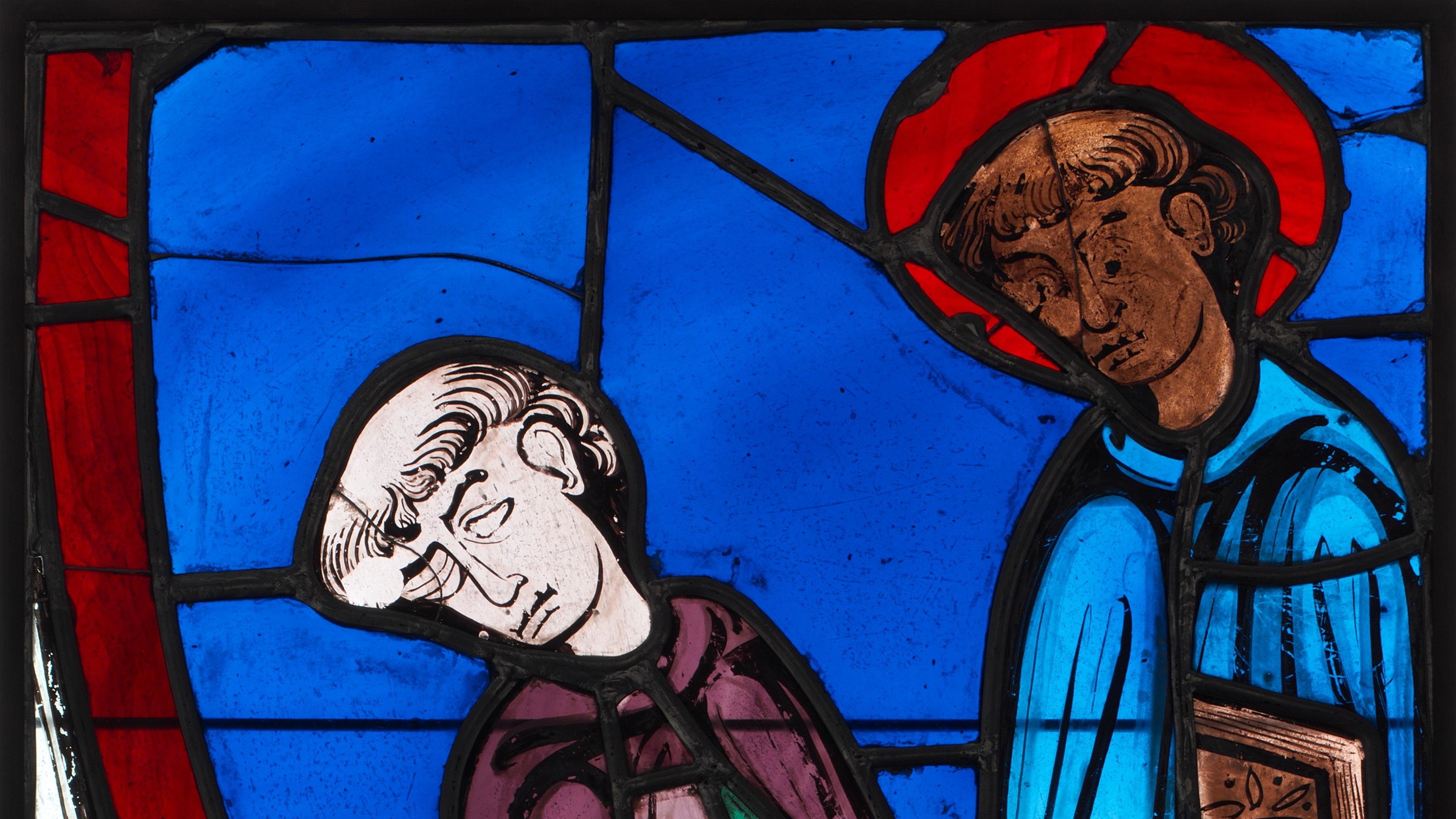 Stained glass artwork depicting two figures in medieval attire, one seated and sleeping, the other standing, on a blue background.