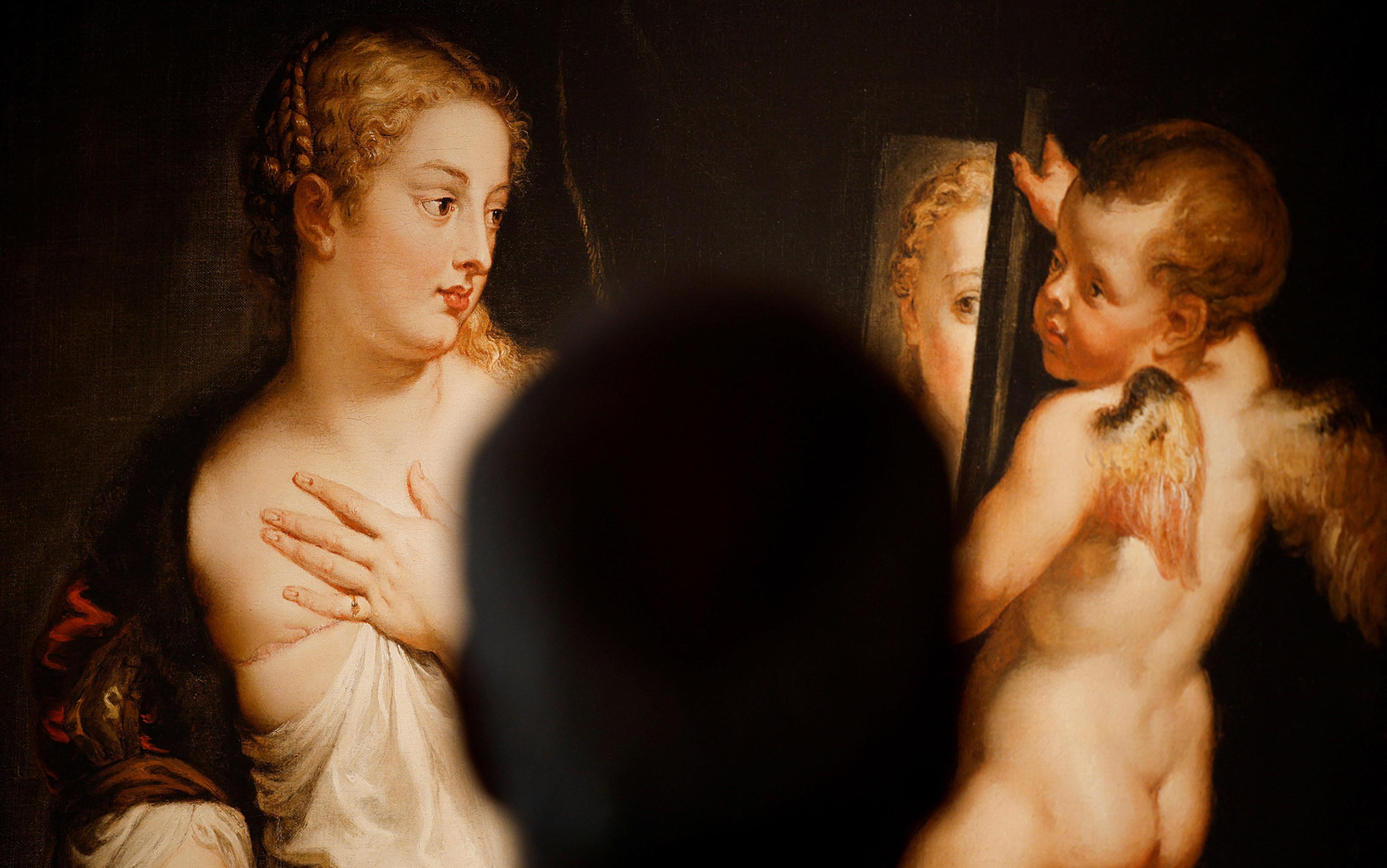 Rubens painting Venus and Cupid reimagined with Venus on the left gazing in a mirror at her mastectomized breast. A cherub like Cupid to the right holds the mirror