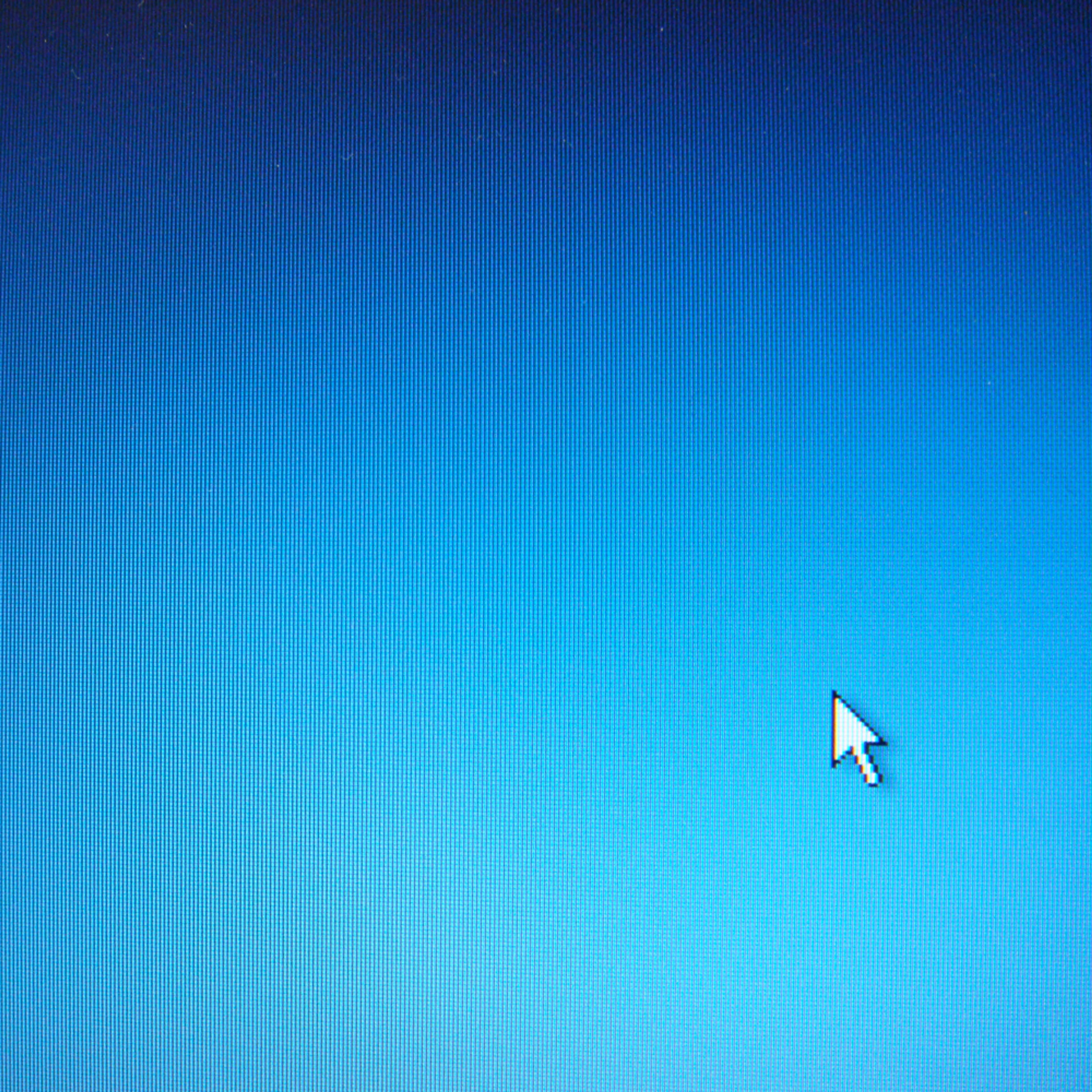 A computer screen with a blue background and a white arrow cursor in the bottom-right corner.