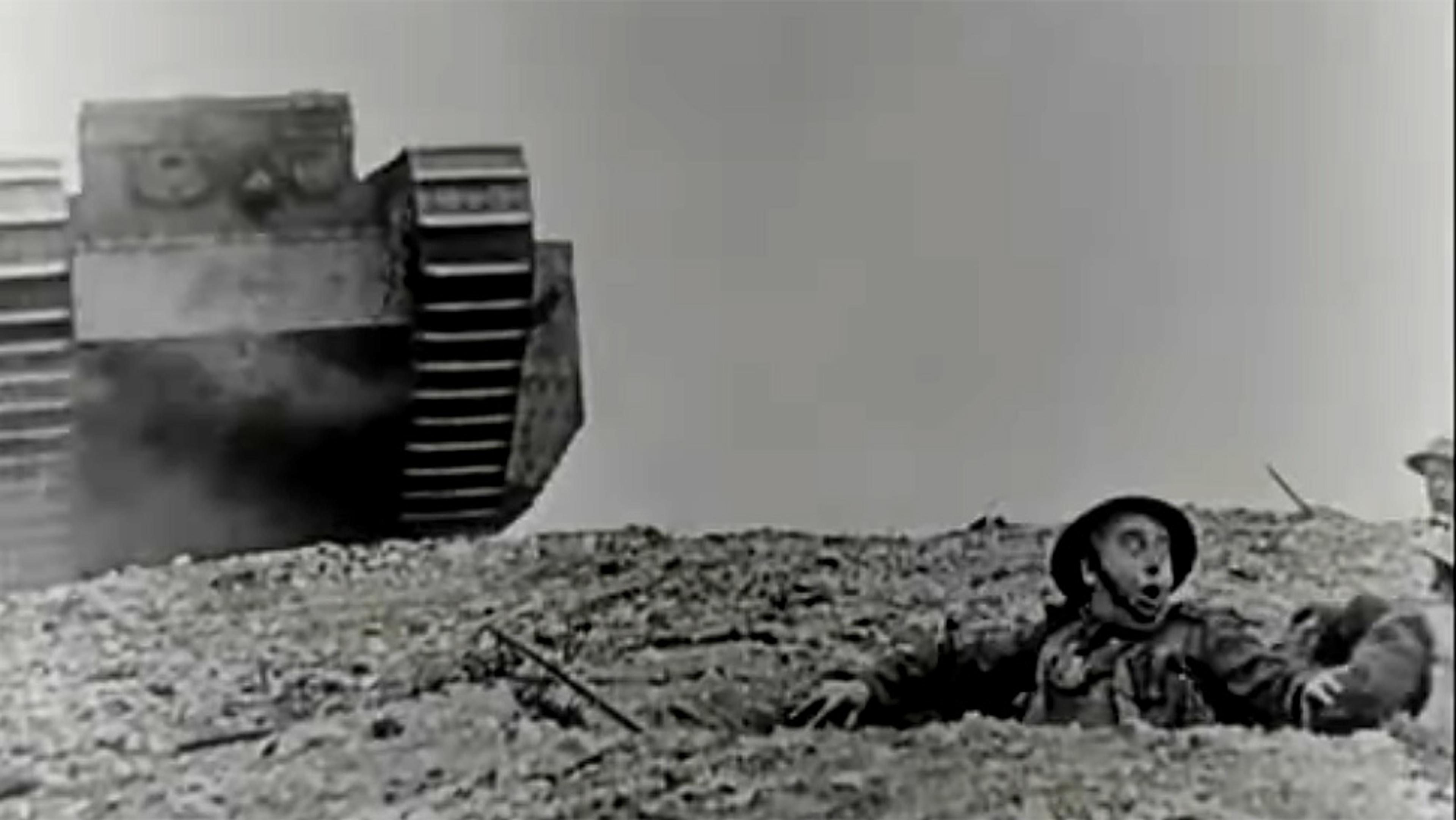 Black-and-white photo of a tank advancing over a trench, where soldiers are reacting with surprise and fear as it approaches.