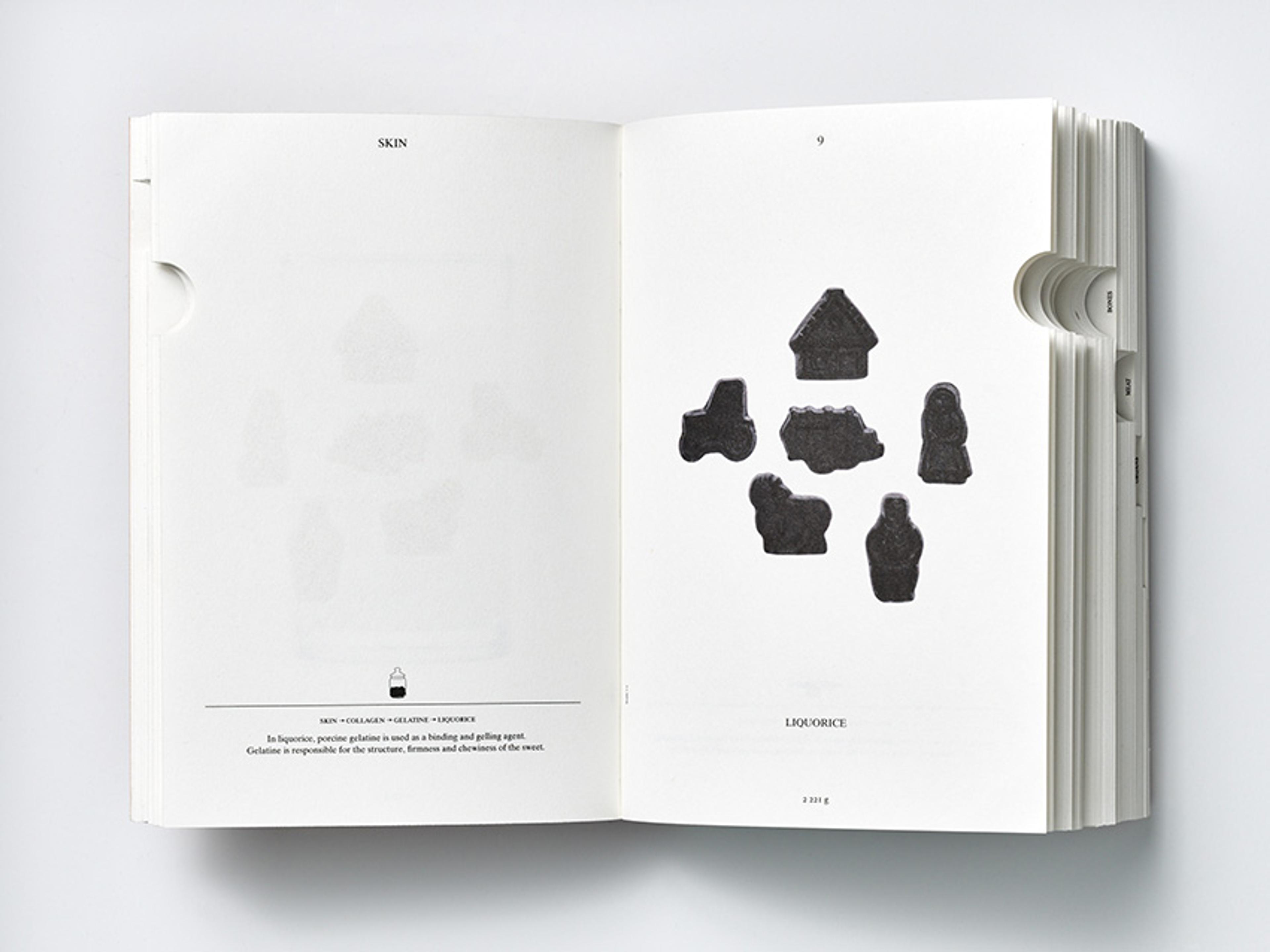 An open book displaying black liquorice sweets in various shapes on the right page. Text can be seen on both pages.