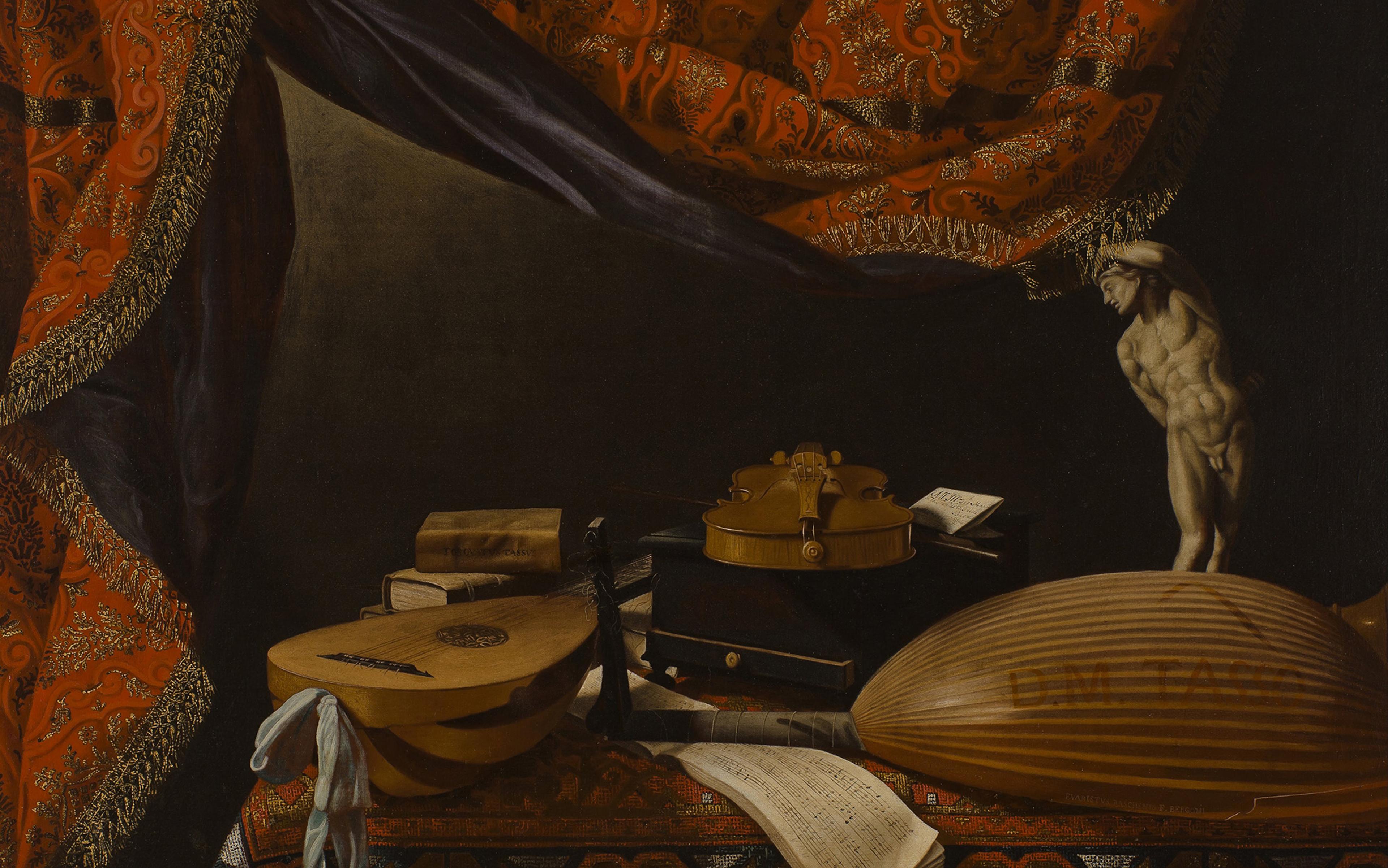 Still life with musical instruments, sheet music, books, and a small statue on a table draped with a richly patterned red and gold curtain.