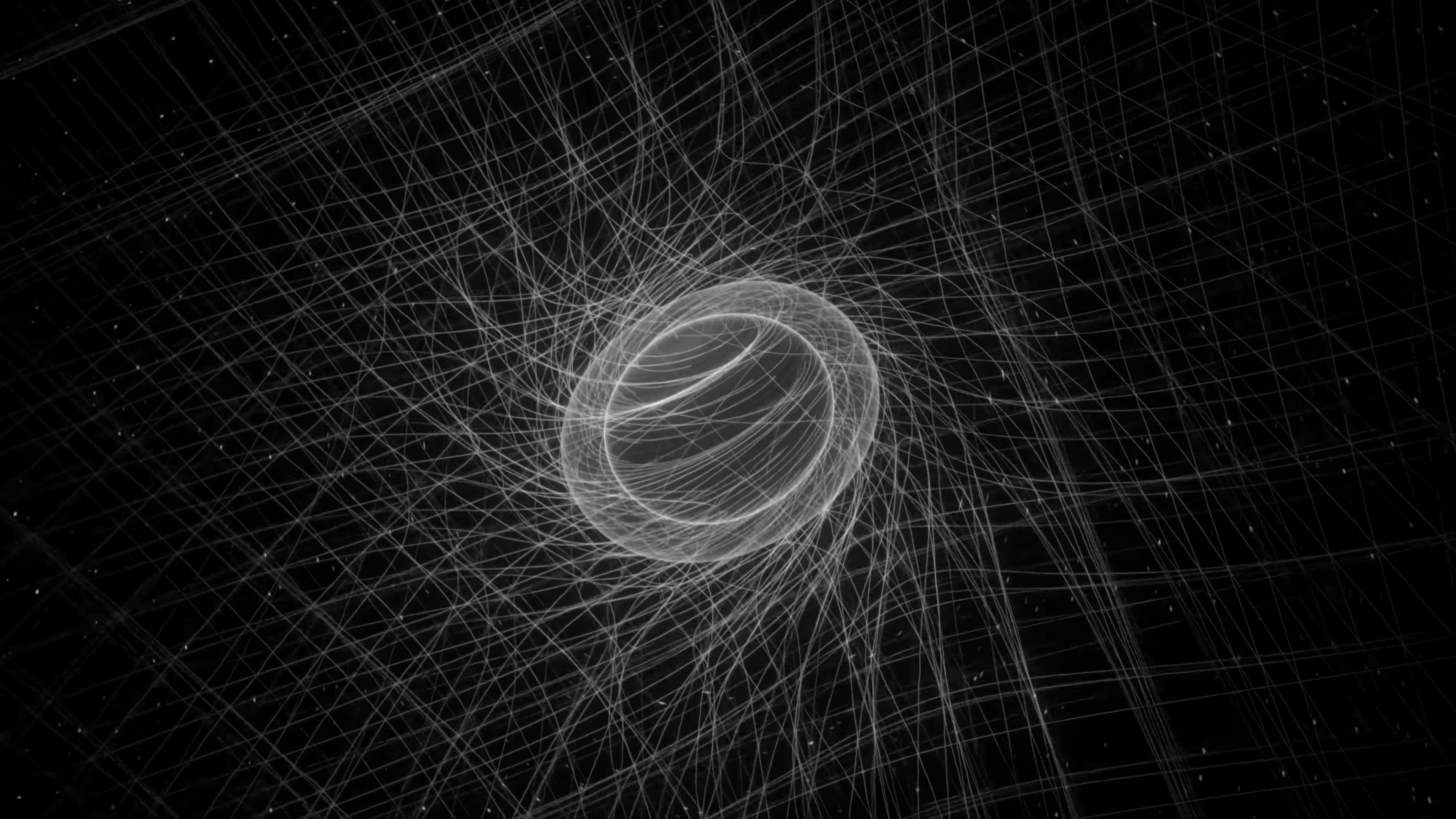 Abstract black-and-white image featuring a spherical shape at the centre surrounded by an intricate web of swirling, crisscrossing lines, creating a three-dimensional effect. The background is dark, enhancing the contrast and emphasising the white lines and central sphere.
