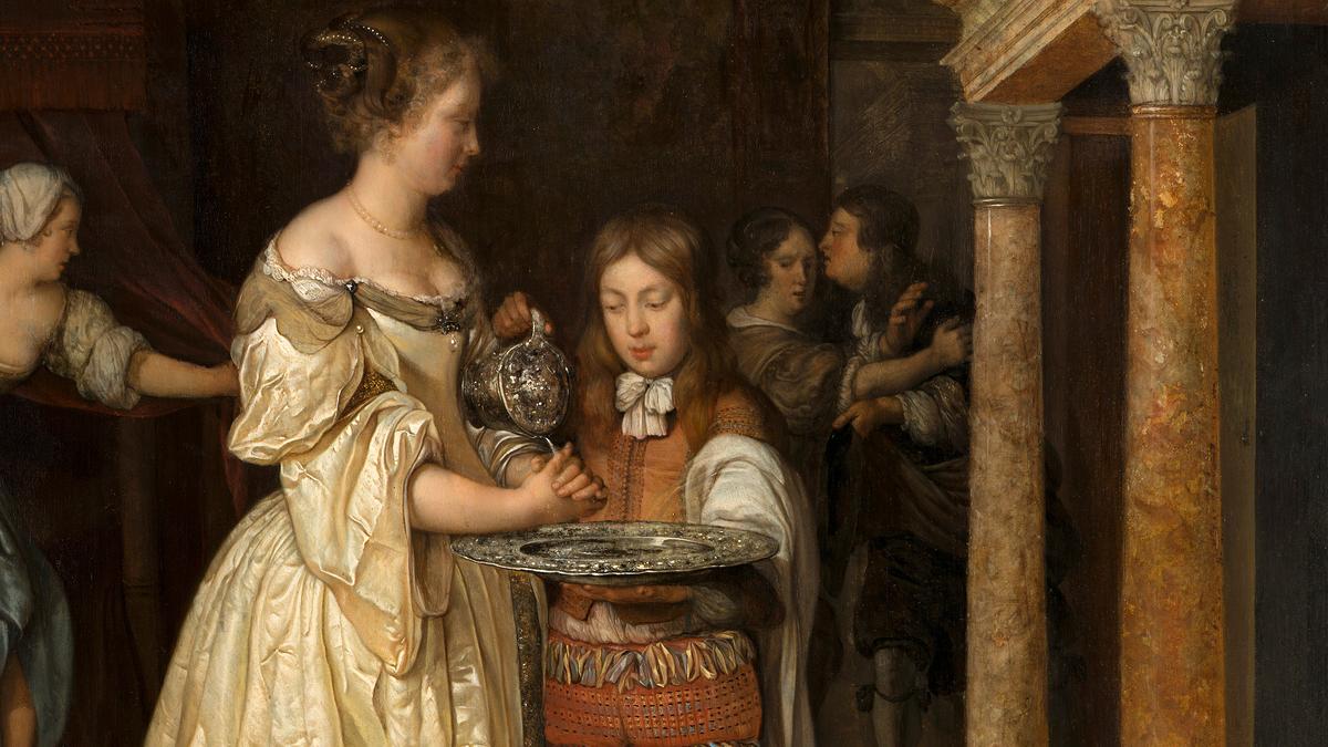 Woman in historical dress washing her hands with water poured by a child from a jug, with onlookers in an ornate interior setting.