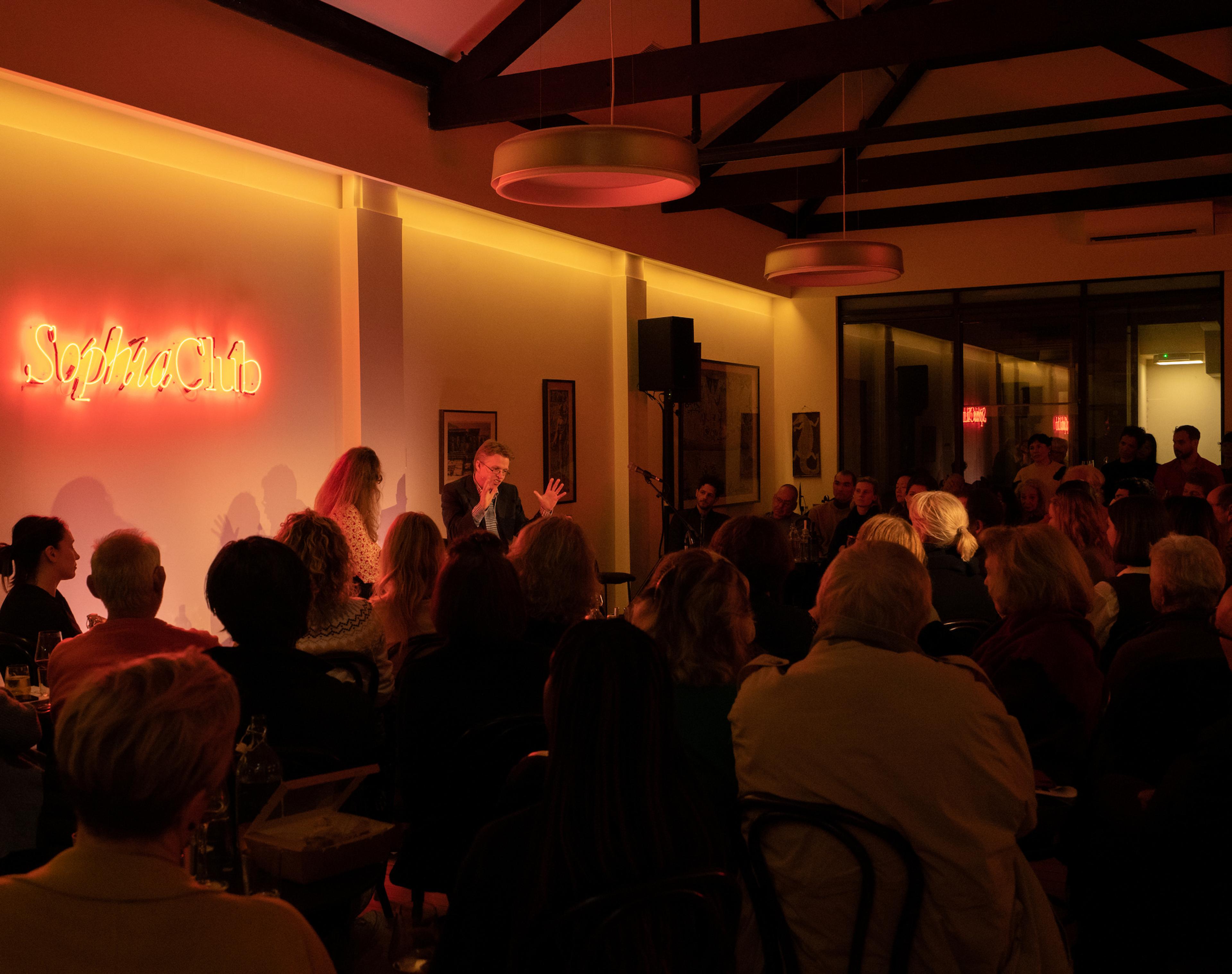 Tom Cochrane on stage in conversation with Brigid Hains