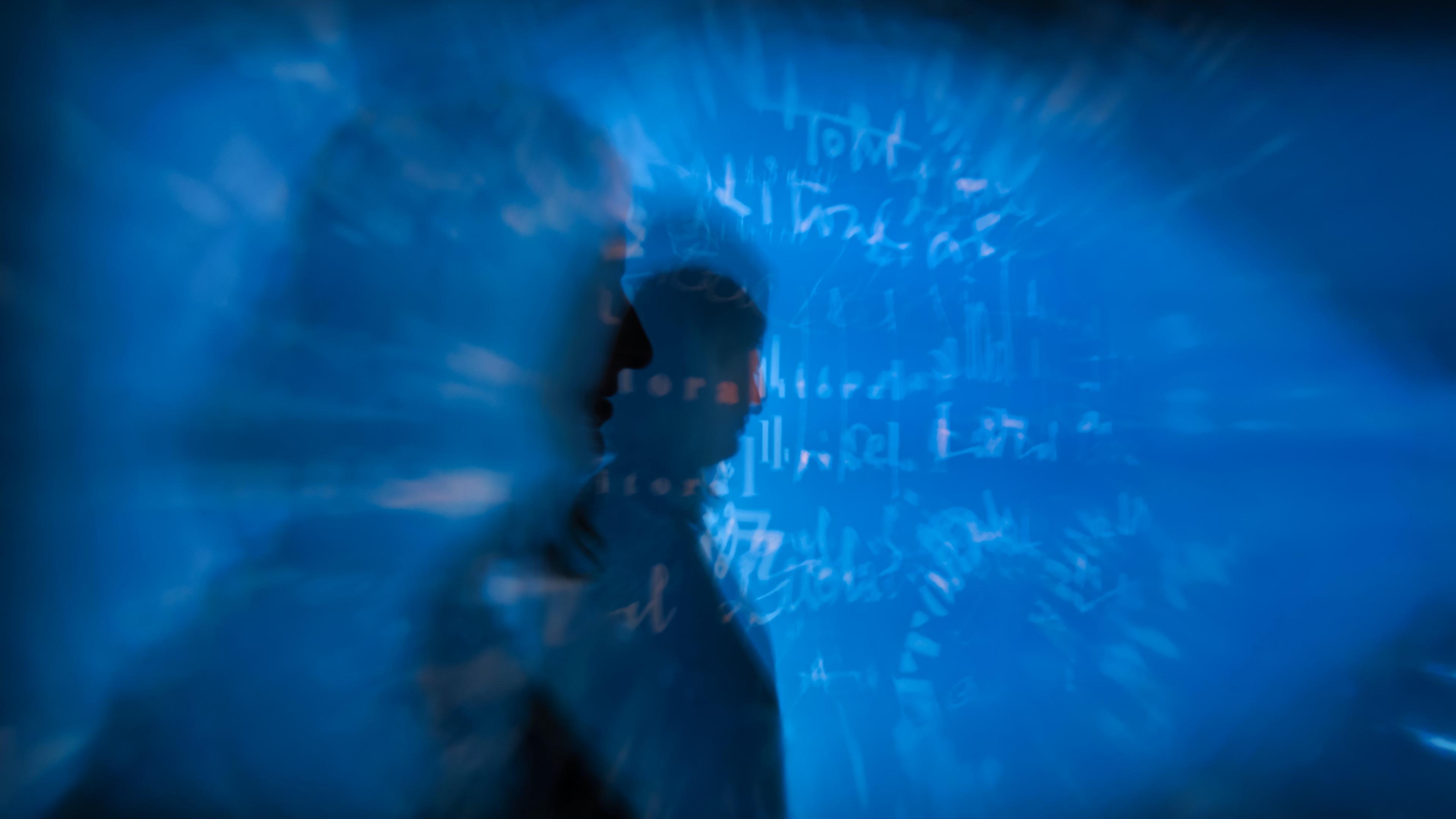 Abstract image of a silhouette against blue light with blurred text in the background, digital art.