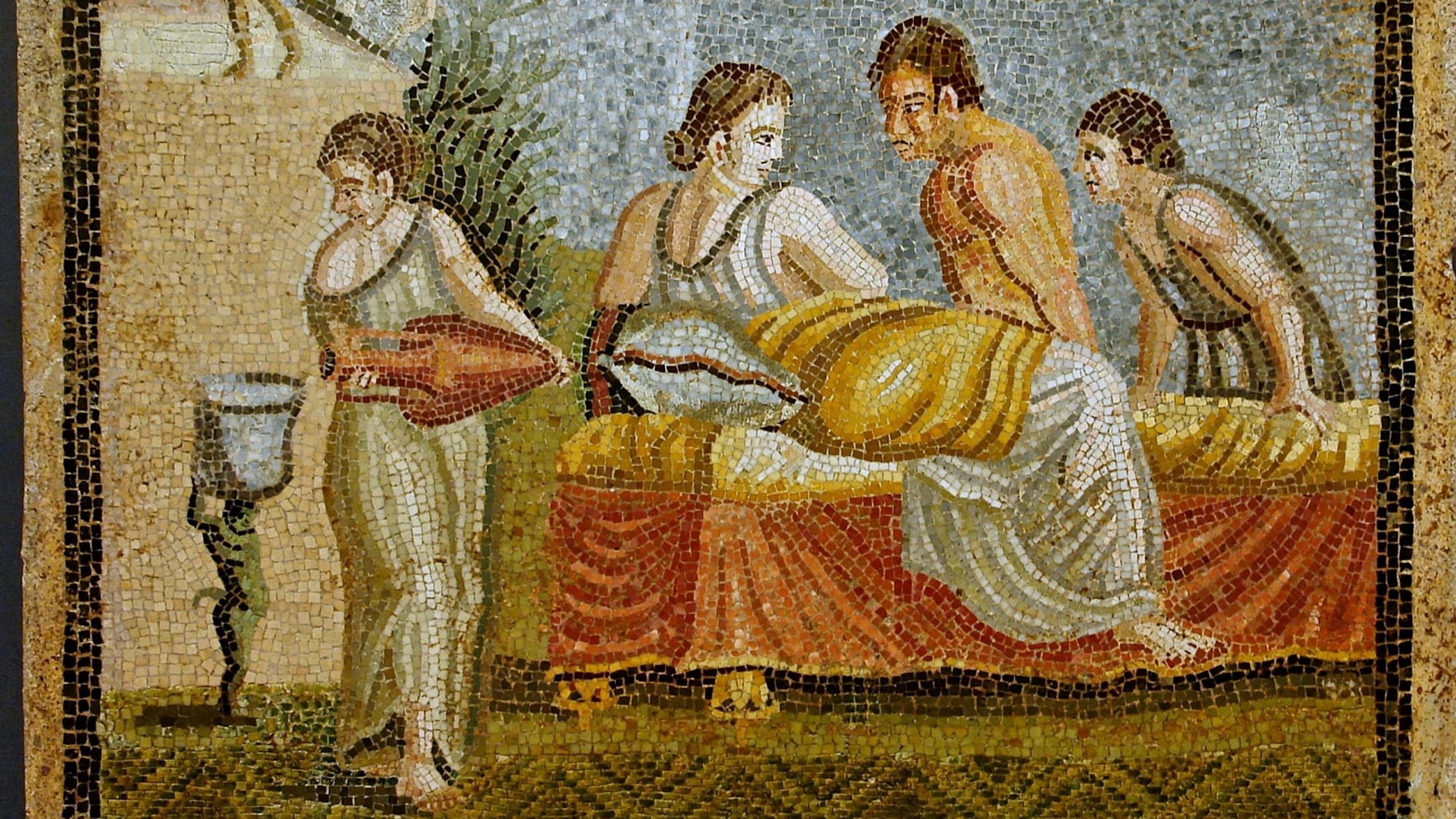 Ancient Roman mosaic of four people gathered around a reclined figure on a bed with draped fabric overhead.