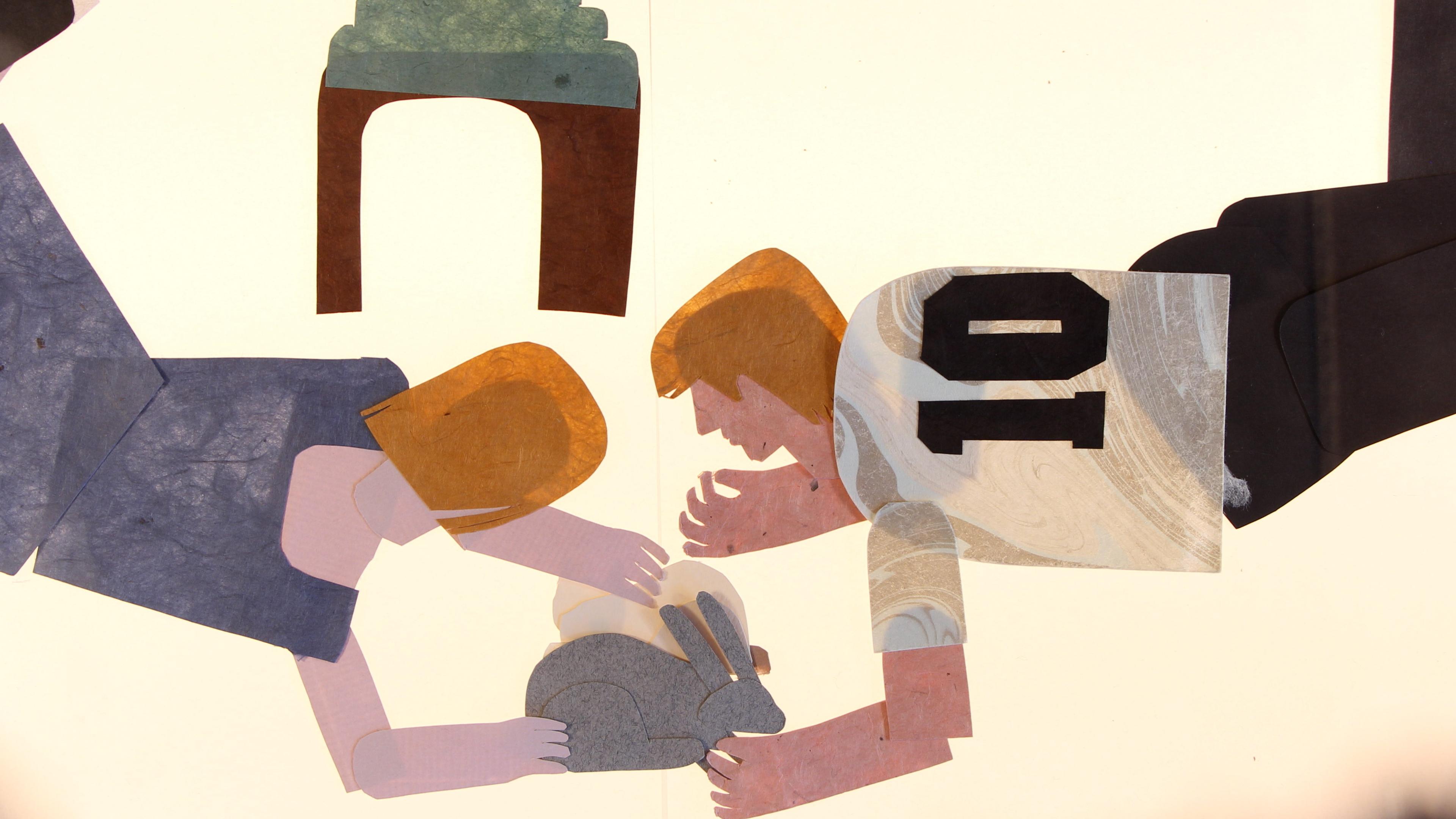 Paper collage of a man and a woman lying on the floor petting a grey rabbit and a white cat with a small table in the background.