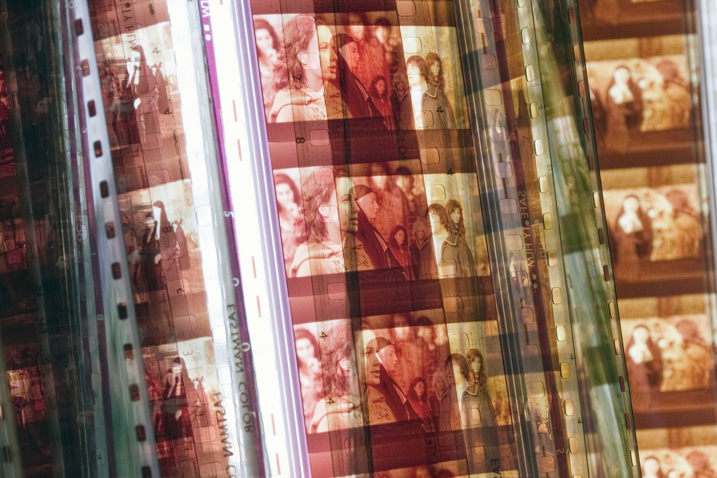 Overlapping filmstrips with frames showing various people in warm tones, creating a layered visual effect.