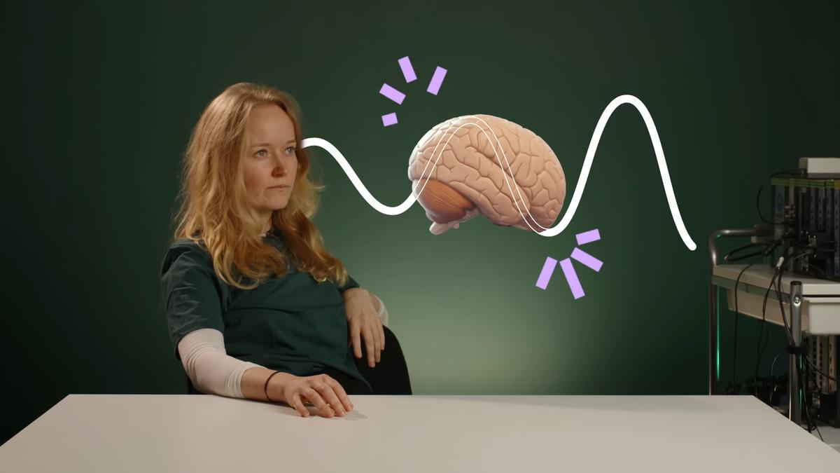 A person sitting beside a graphic brain illustration with wave patterns on a green background.
