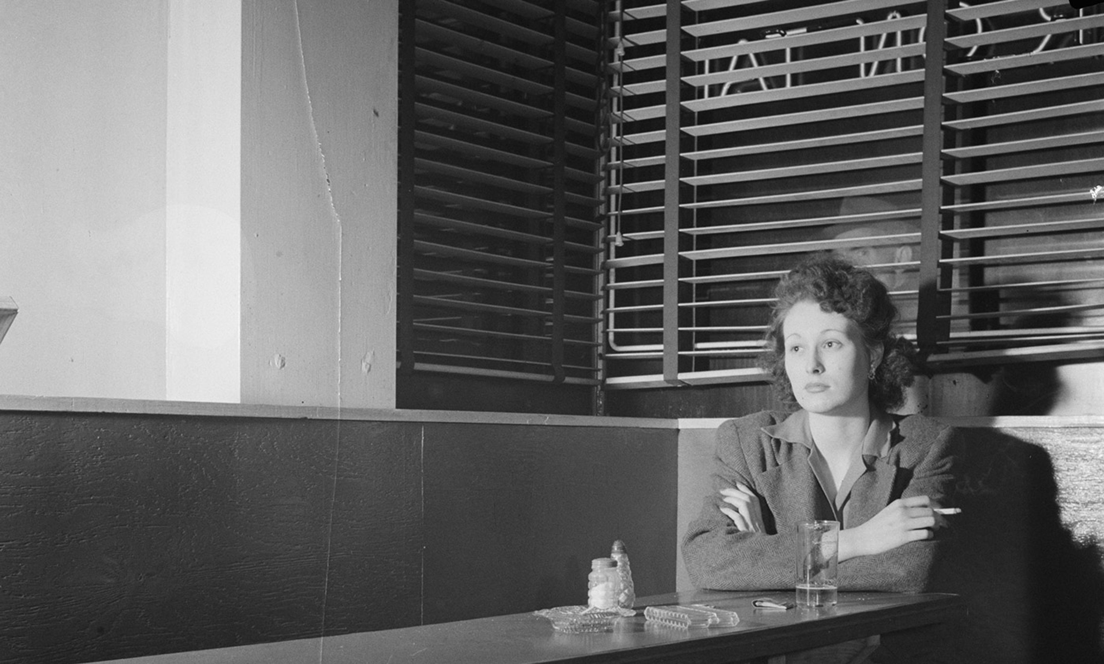 <p>Girl sitting alone in the Sea Grill, a bar and restaurant in Washington, DC, 1943. <em>Photo by Esther Bubley/Library of Congress</em></p>