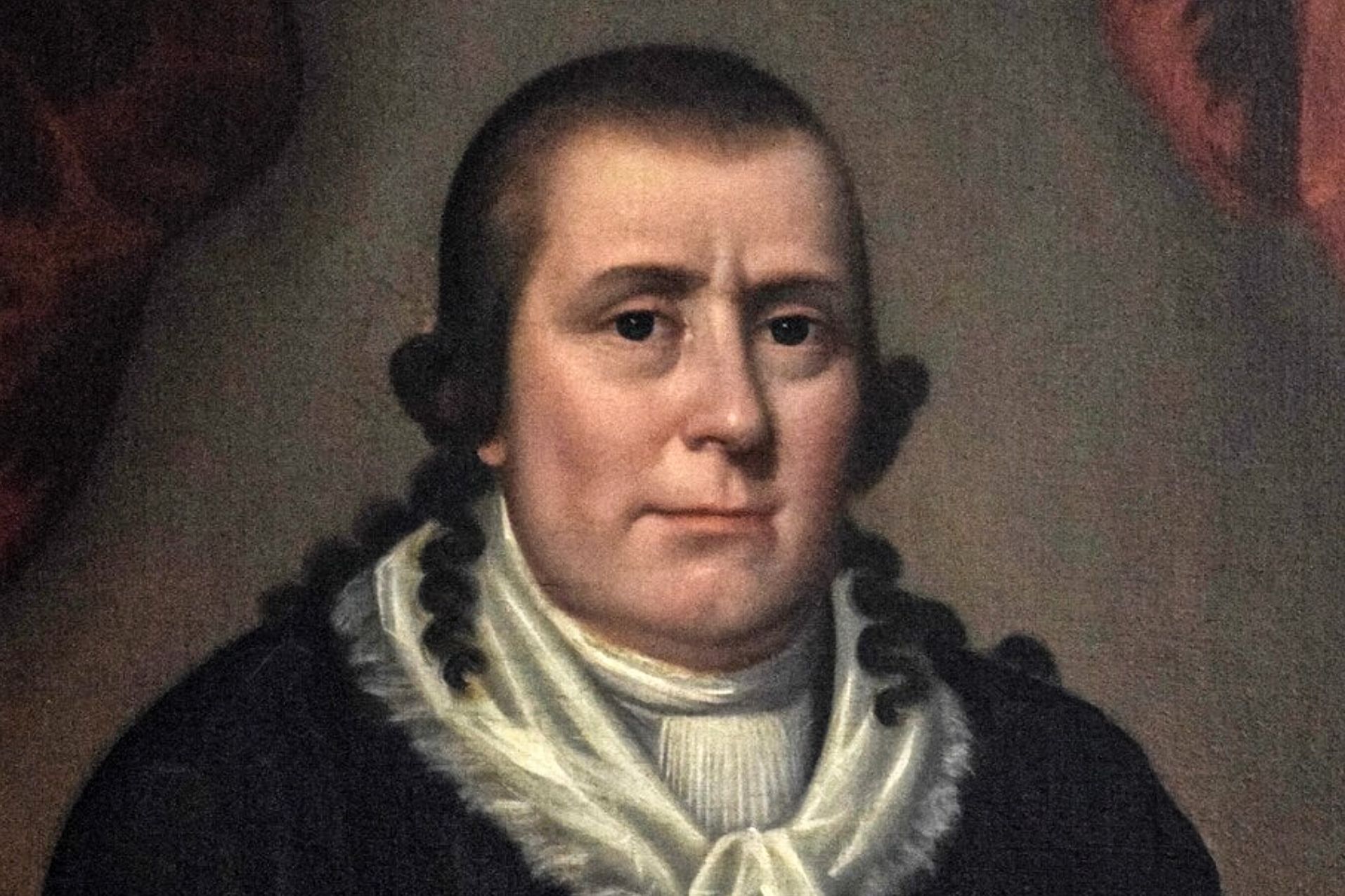 Painting of a man wearing a black coat and white ruffled cravat against a dark background.