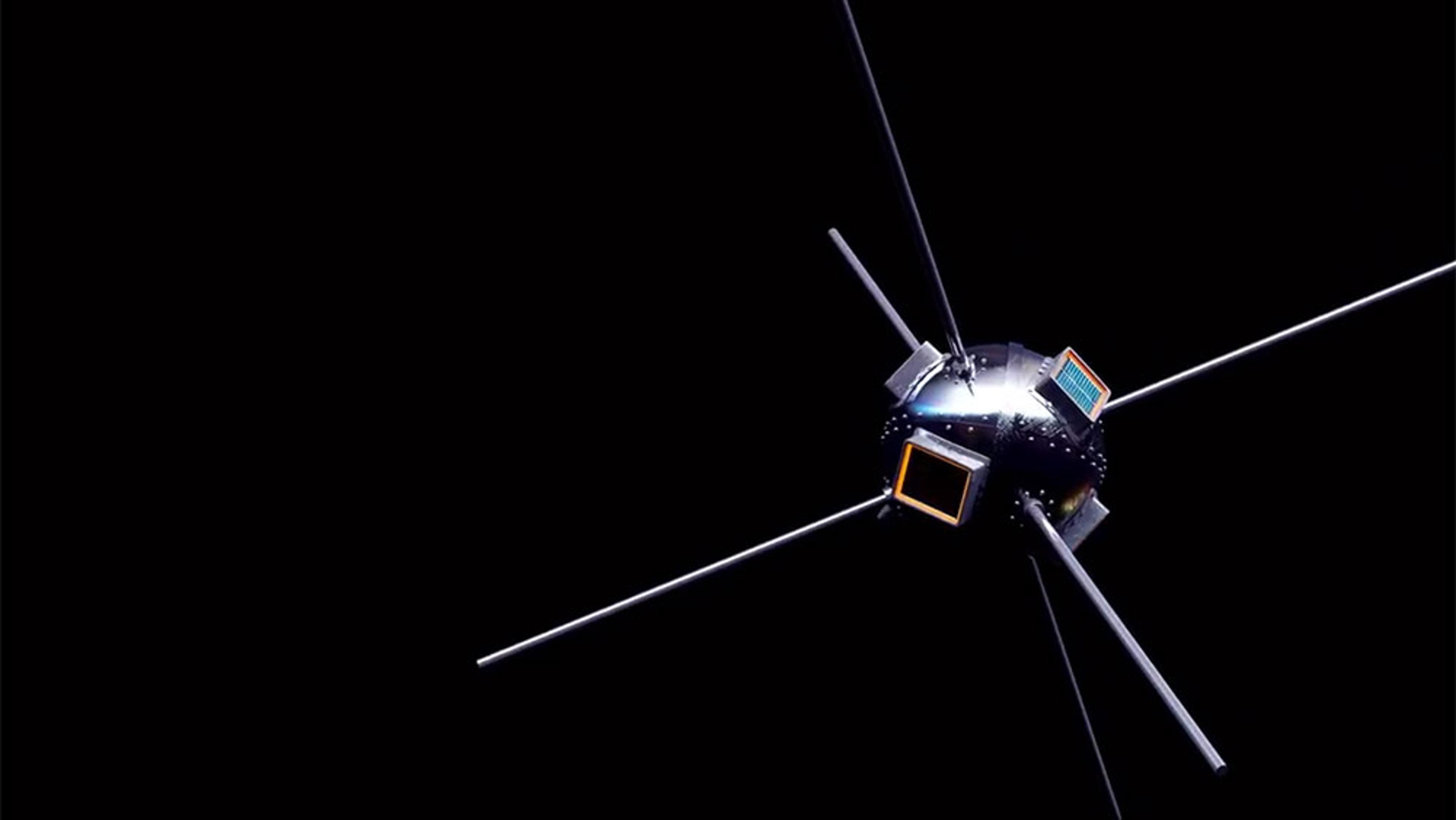 A satellite with a spherical body and multiple antennas extending outward, set against a black background.