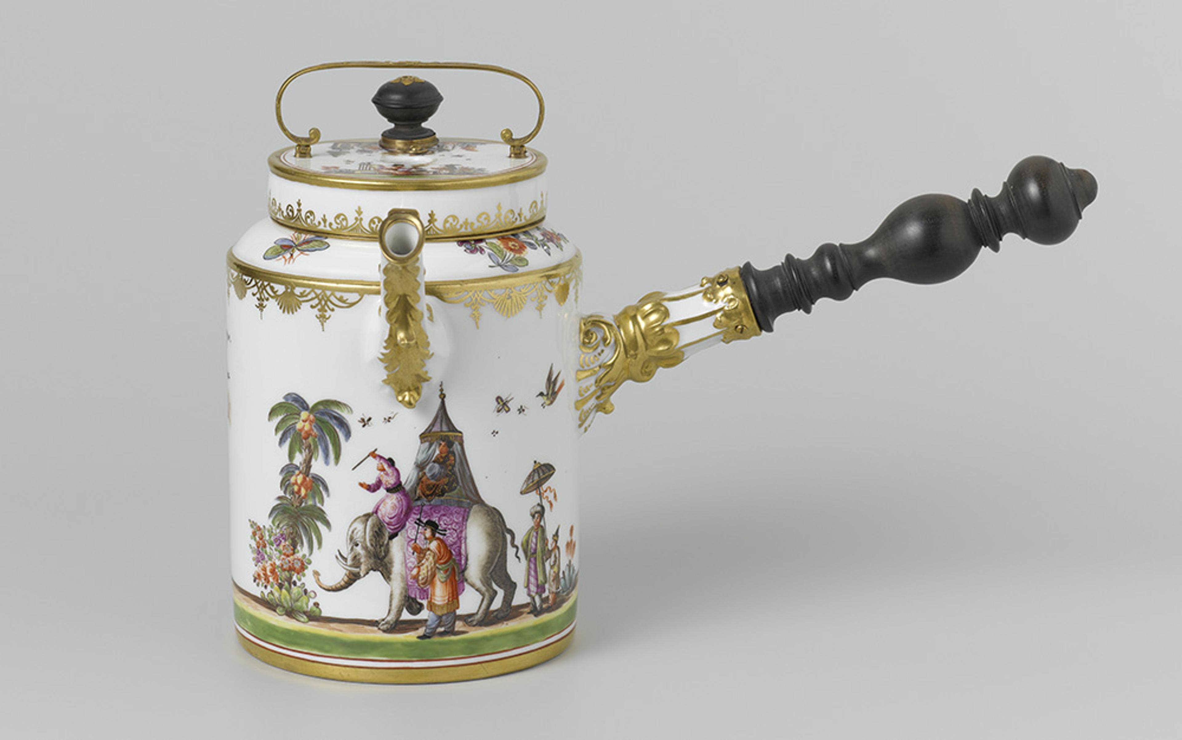 Porcelain coffee pot with a wooden handle, gold decorative elements, and a painted scene featuring people riding an elephant.