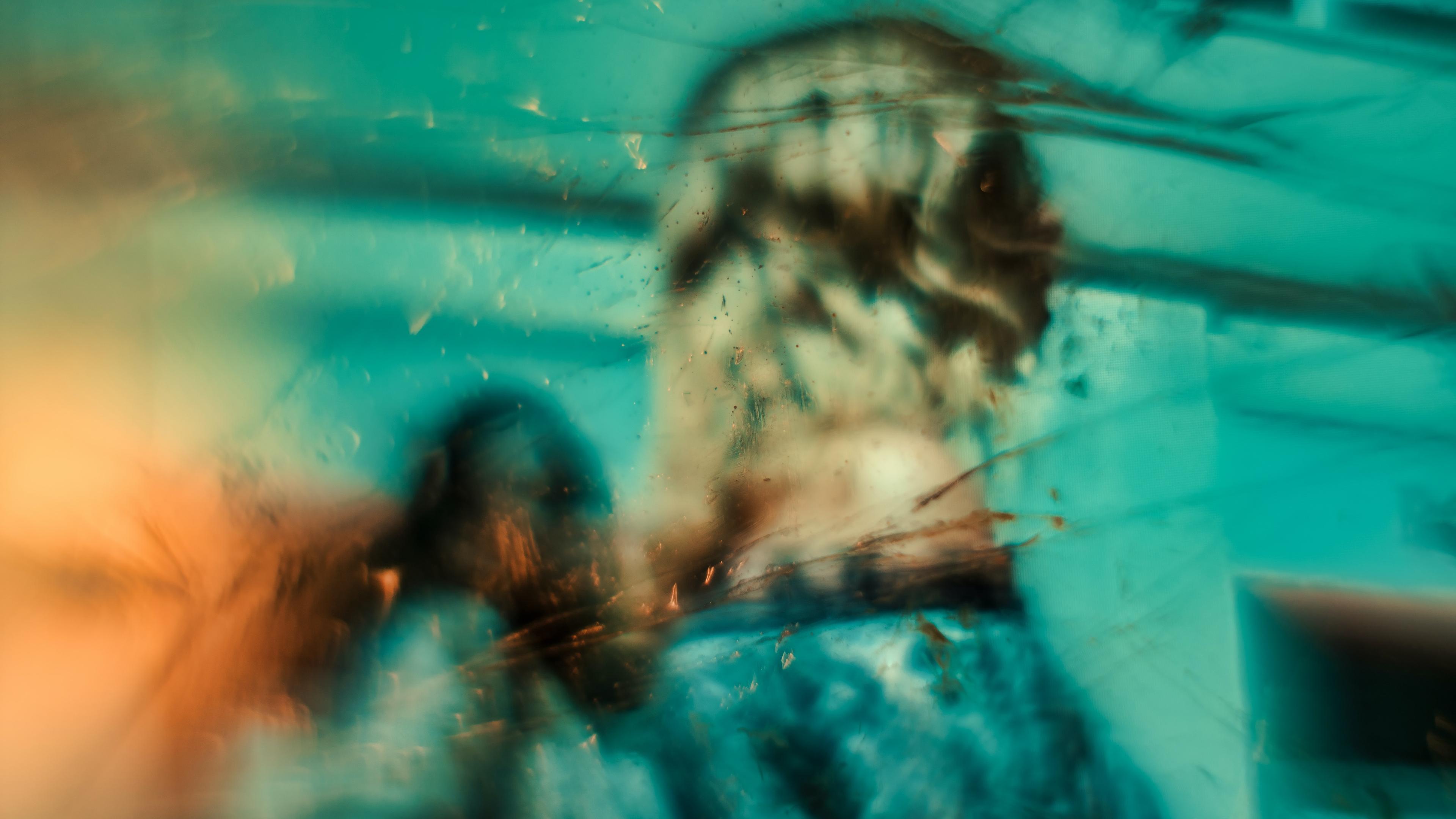 Abstract painting with blurred figures in teal and orange tones suggesting motion and mystery.