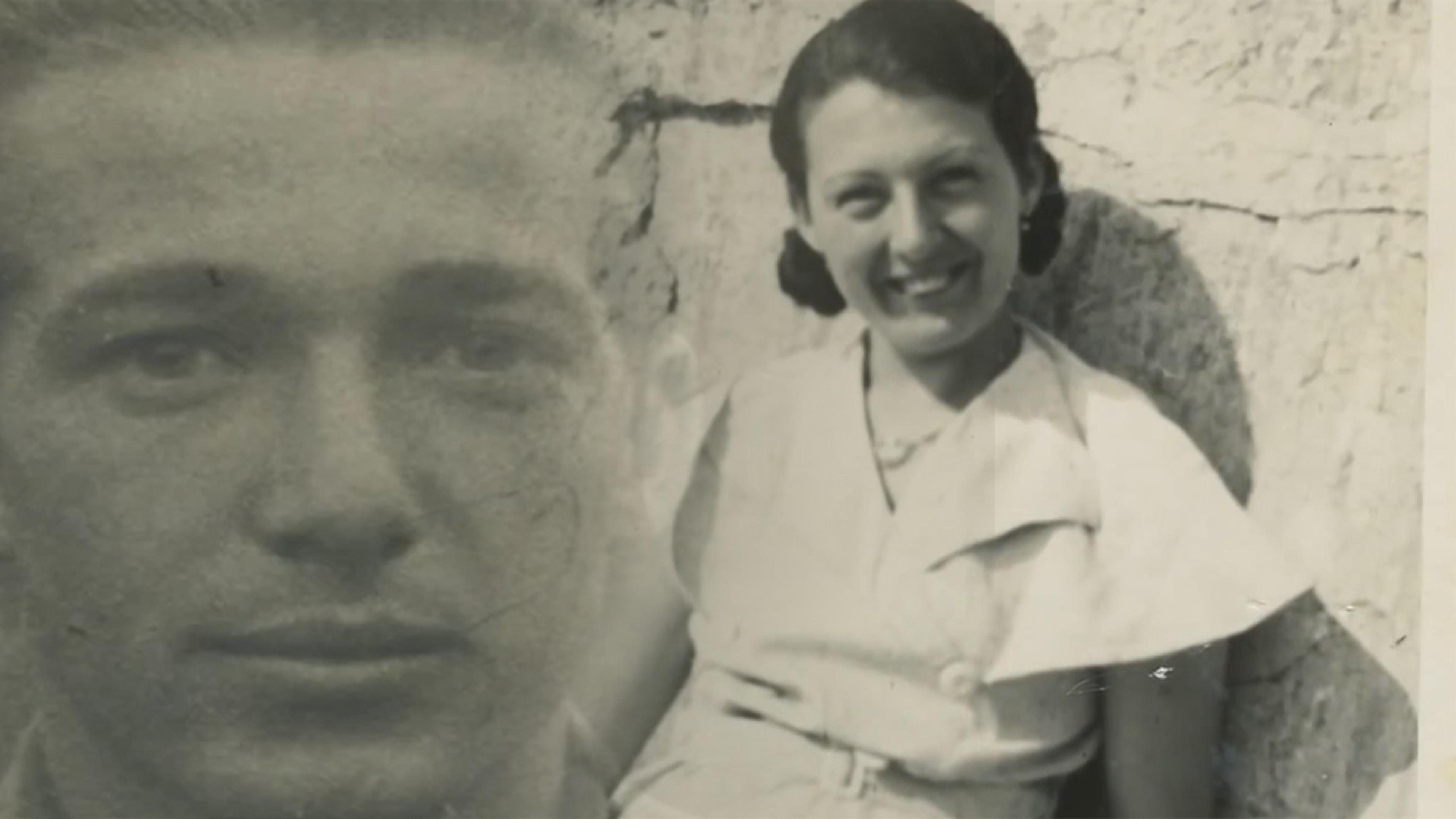 Black and white photo of a young man and woman, with the man’s face faded into the background and the woman smiling against a rough wall.