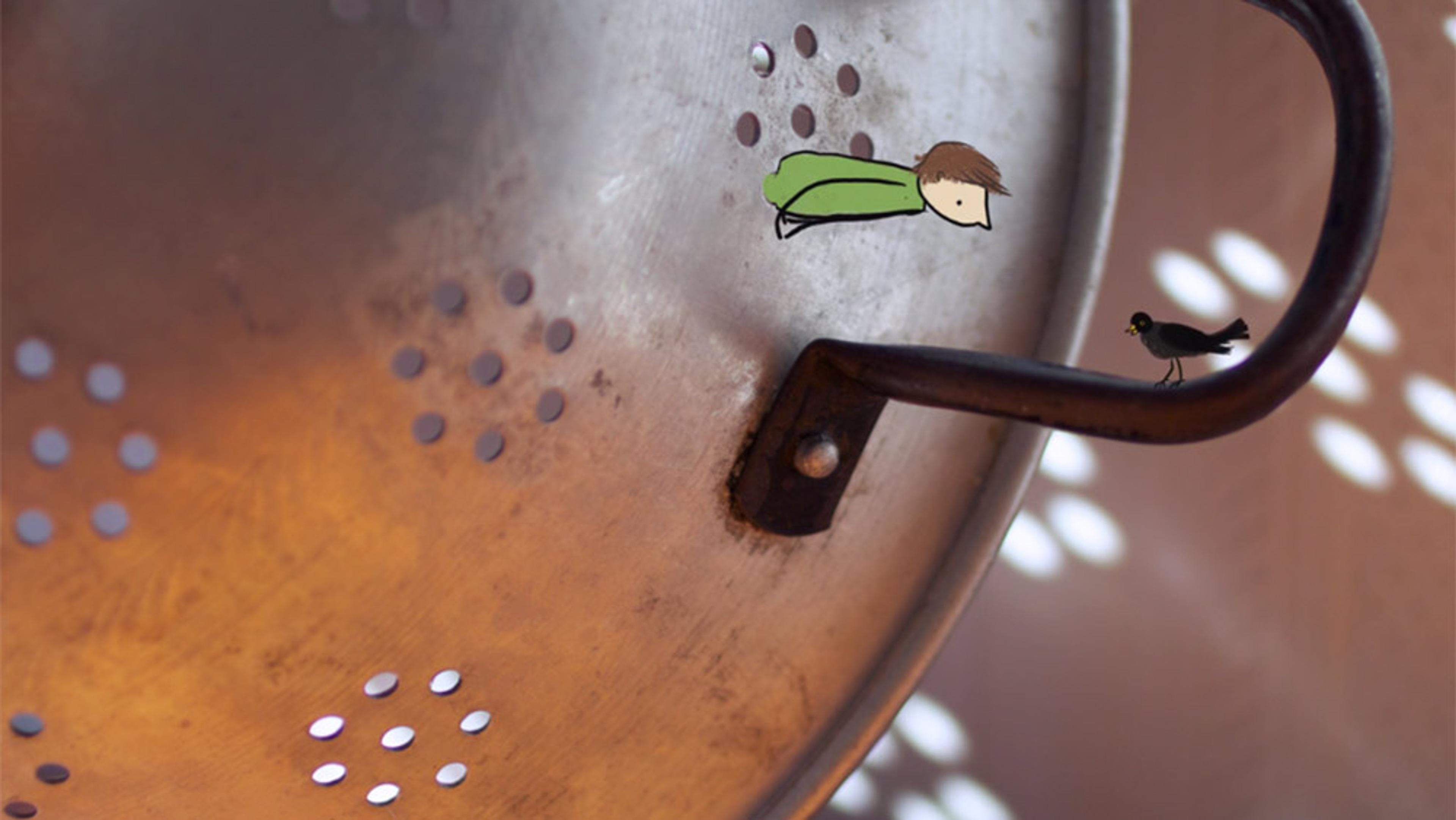 Photo of a metal colander with a small illustrated person peering out through one of the holes and an illustrated bird perched on the handle.