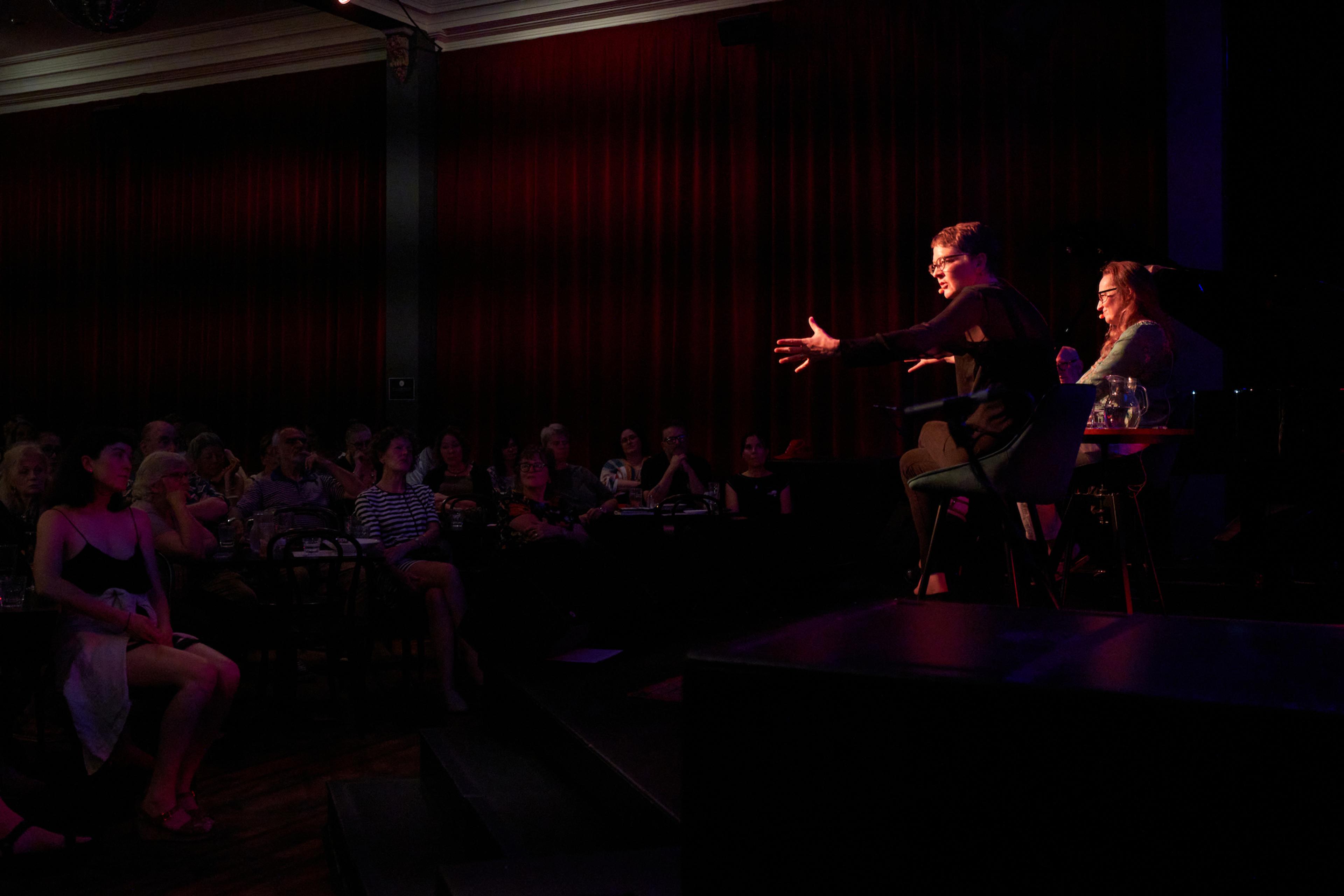 Margaret Cameron and Brigid Hains speaking on stage