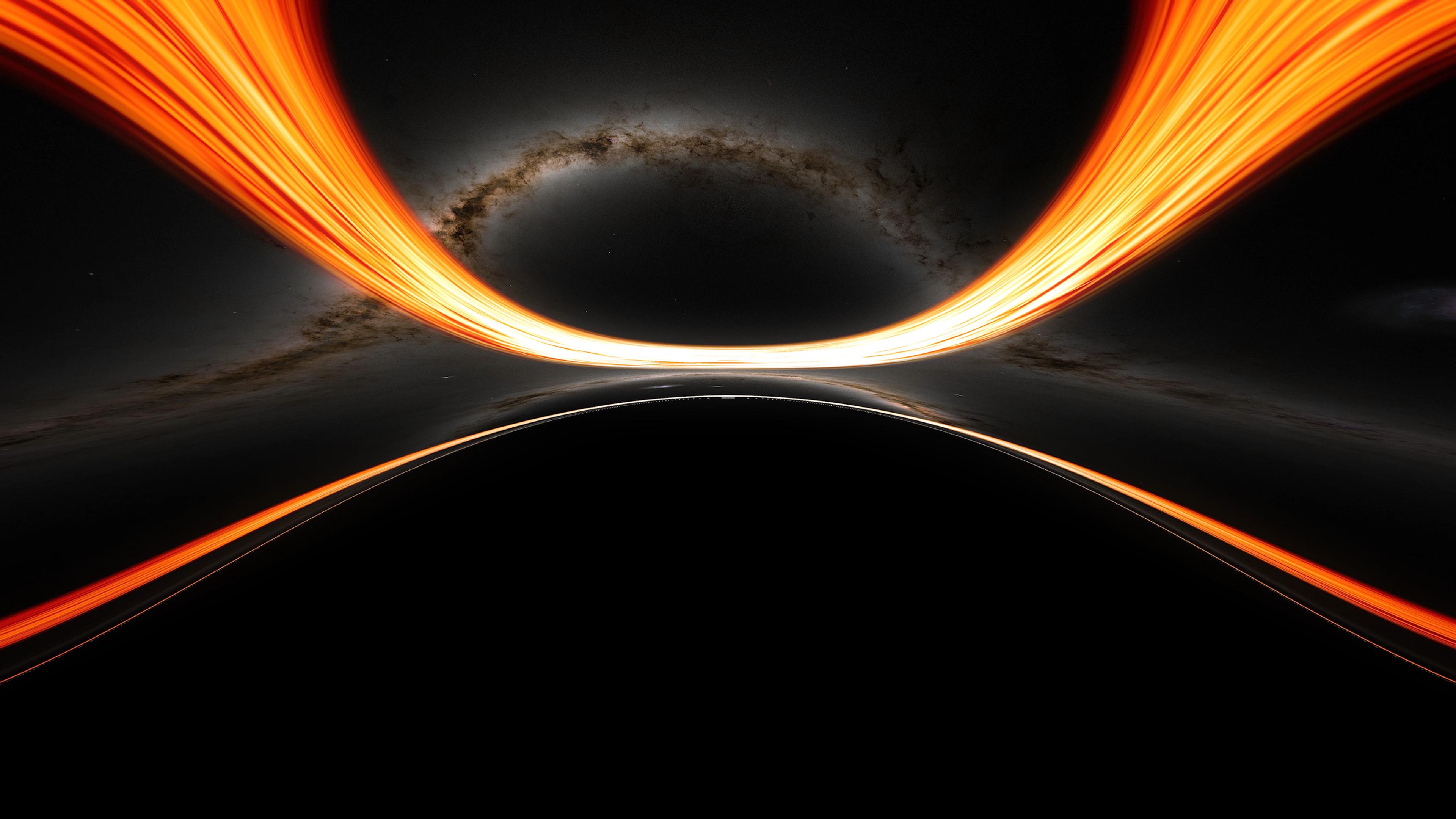 Artistic depiction of a black hole with light bending around its event horizon. A bright orange and yellow swirl of light contrasts against the deep black and dark grey background, illustrating the gravitational pull and bending of light.