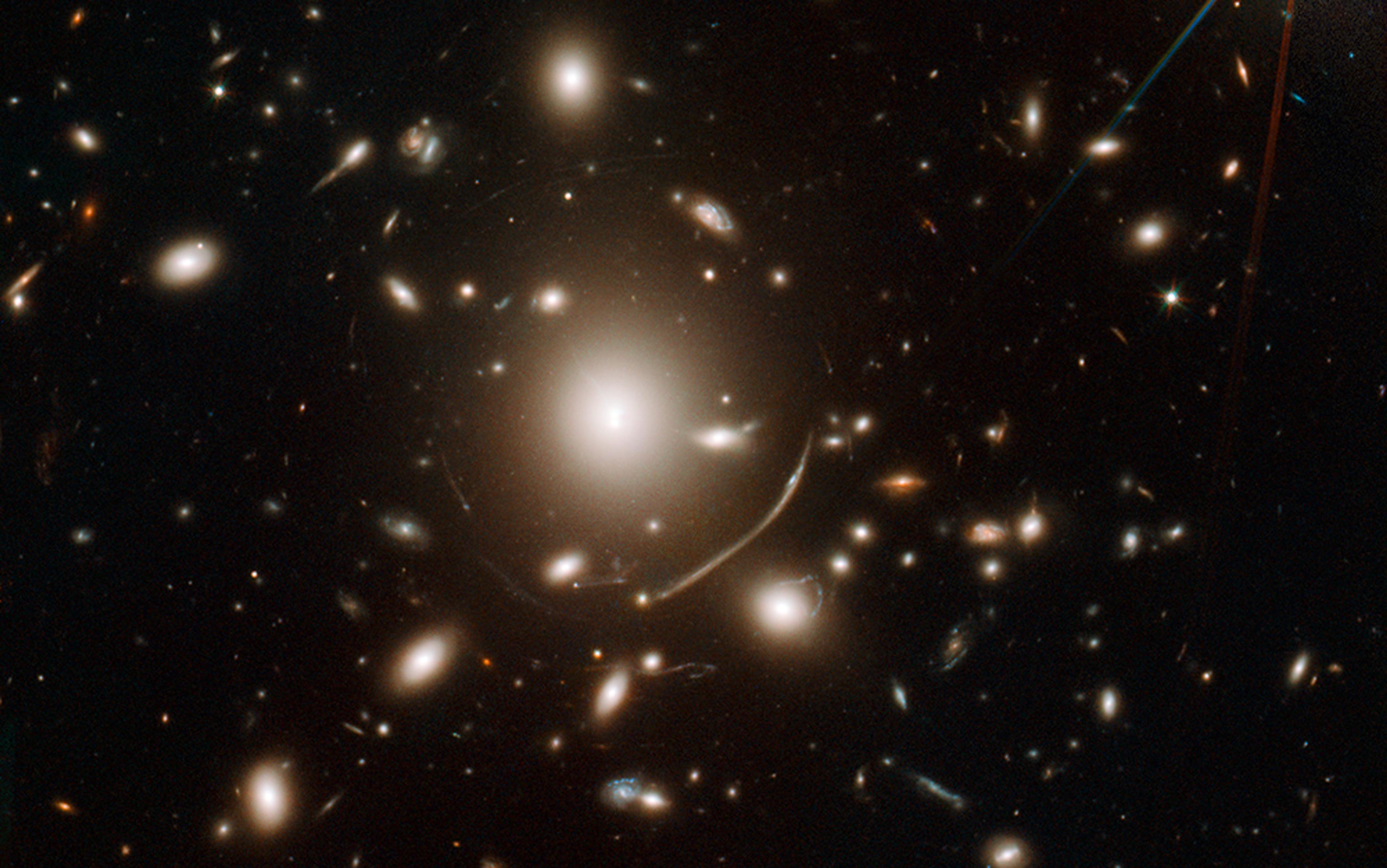 Photo of multiple galaxies with bright stars and other celestial objects visible against the dark backdrop of space