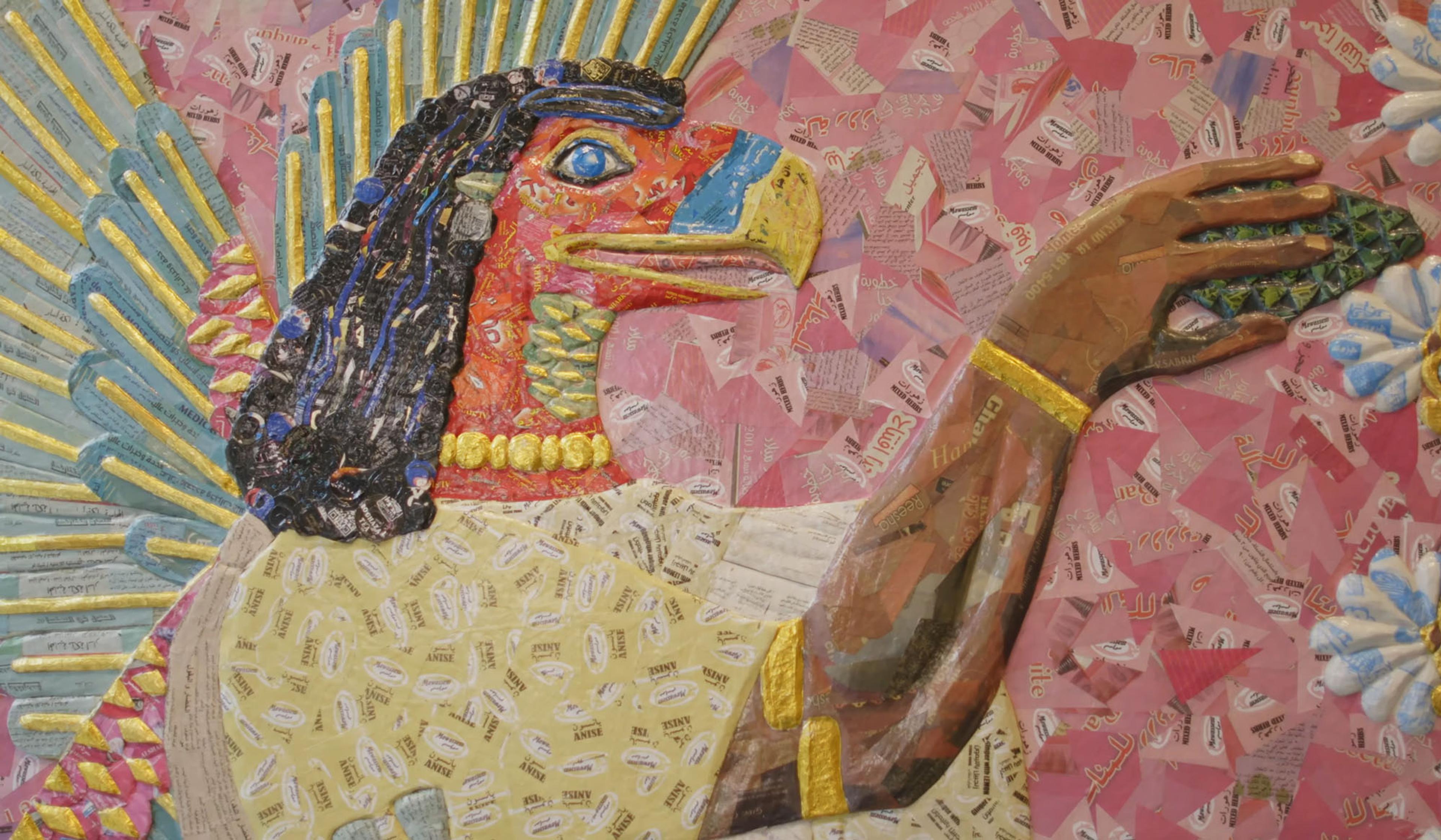 A painting of an Egyptian-style figure with a bird’s head made from a collage of colourful papers on a pink background.