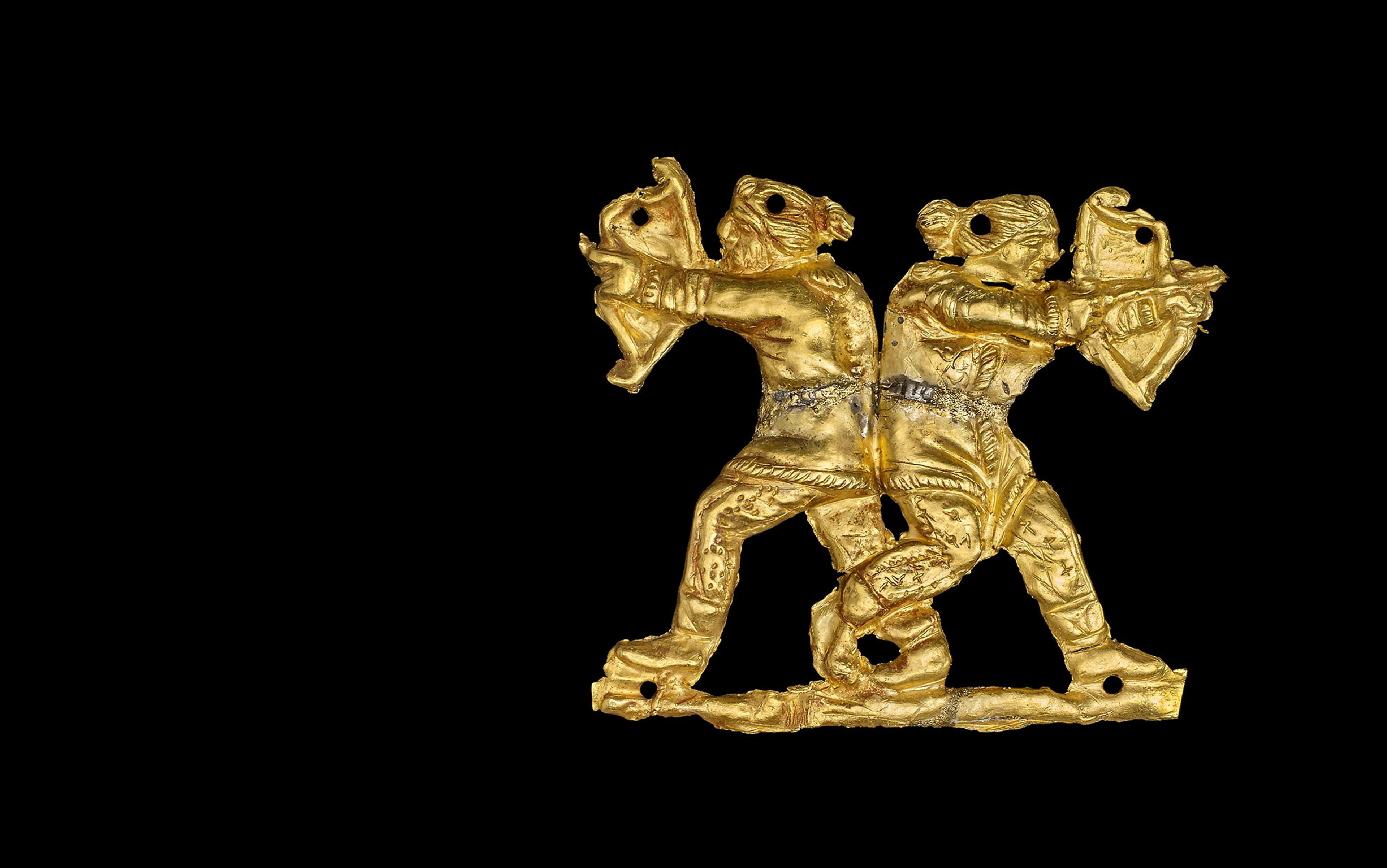 Gold sew-on clothing appliqué in the form of two Scythian archers back to back.