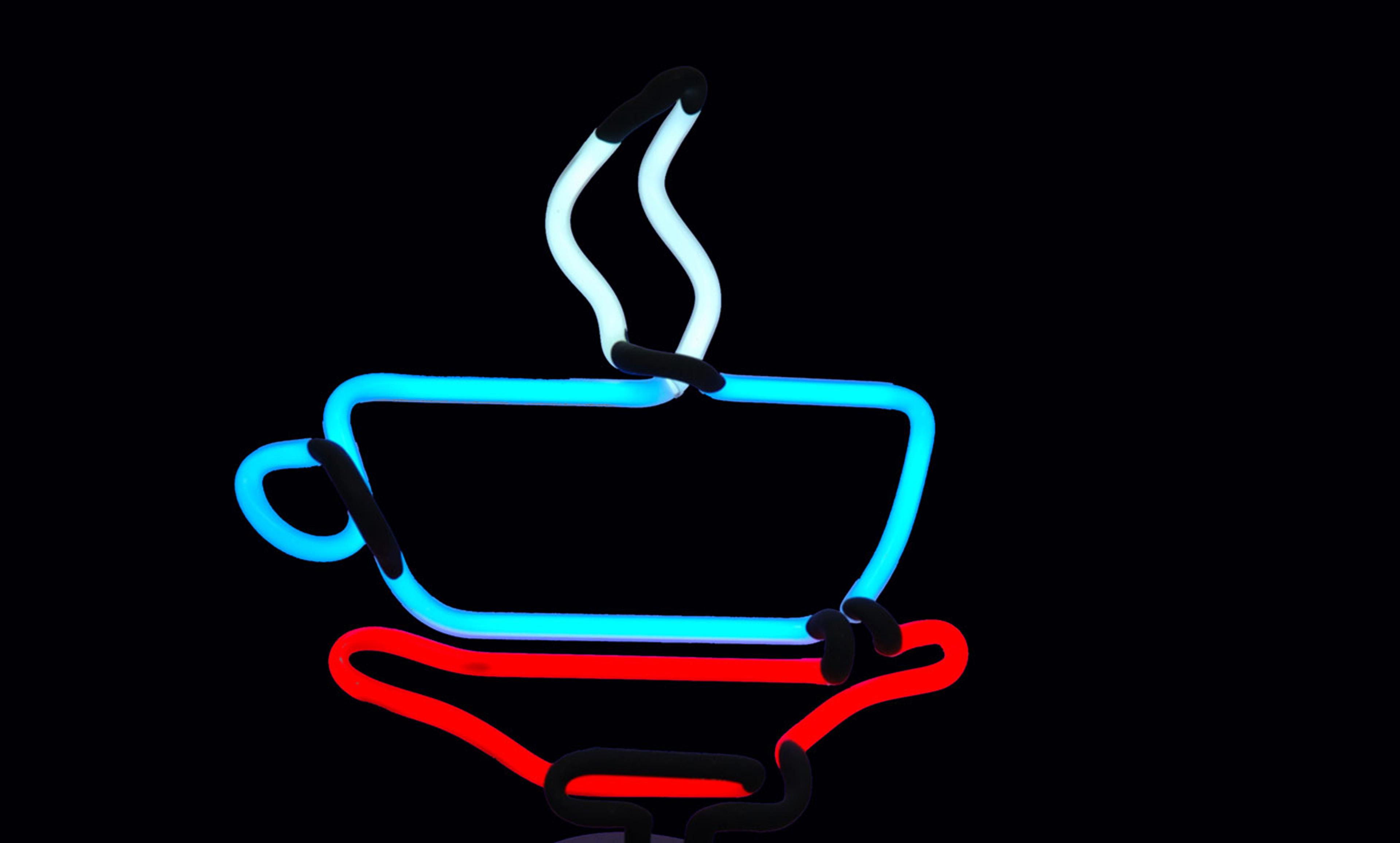 Neon sign of a blue coffee cup with steam rising, resting on a red saucer on a black background.
