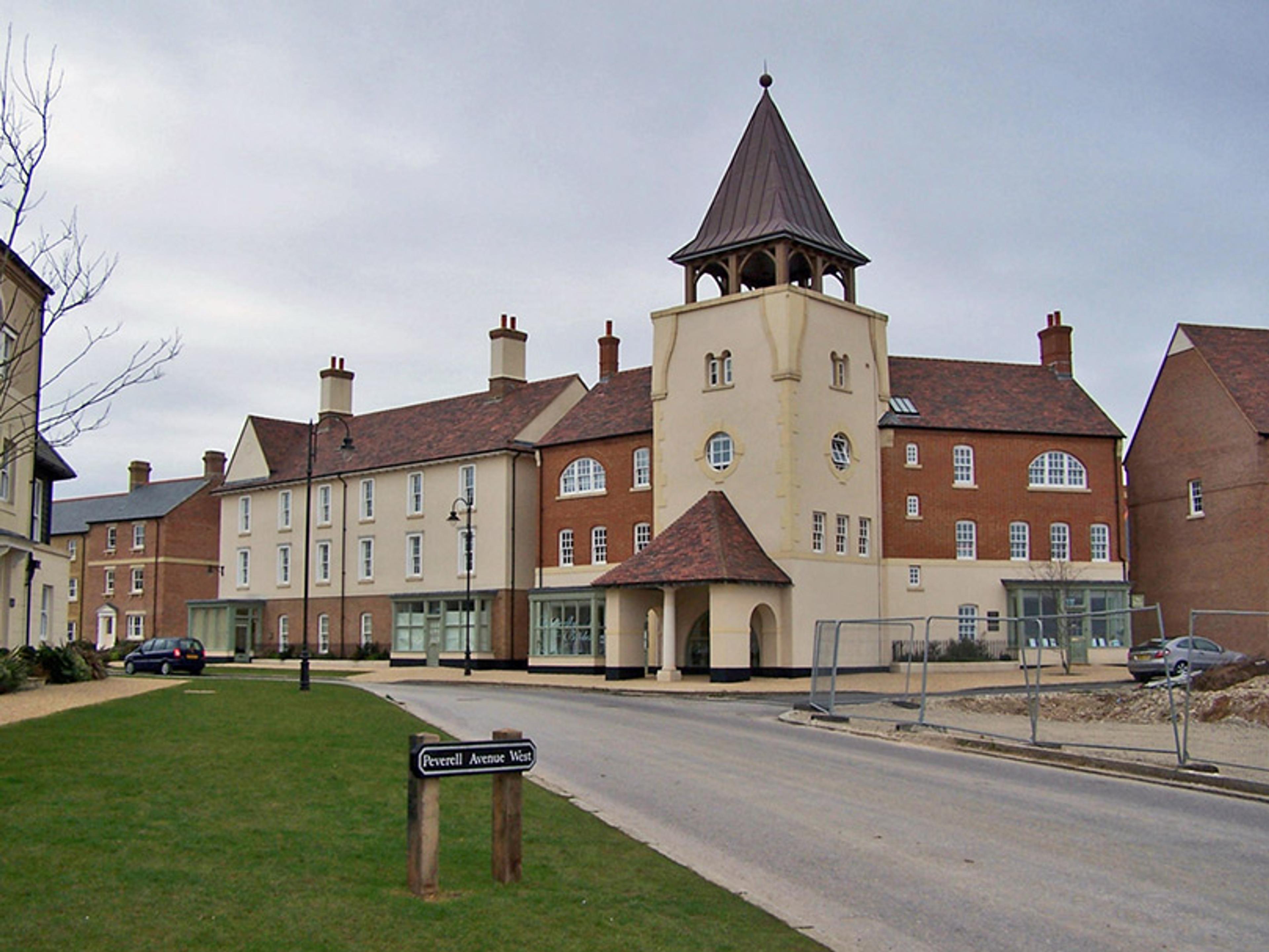 A modern building with a tower, red brick and cream-coloured walls, situated on Peverell Avenue West, England.