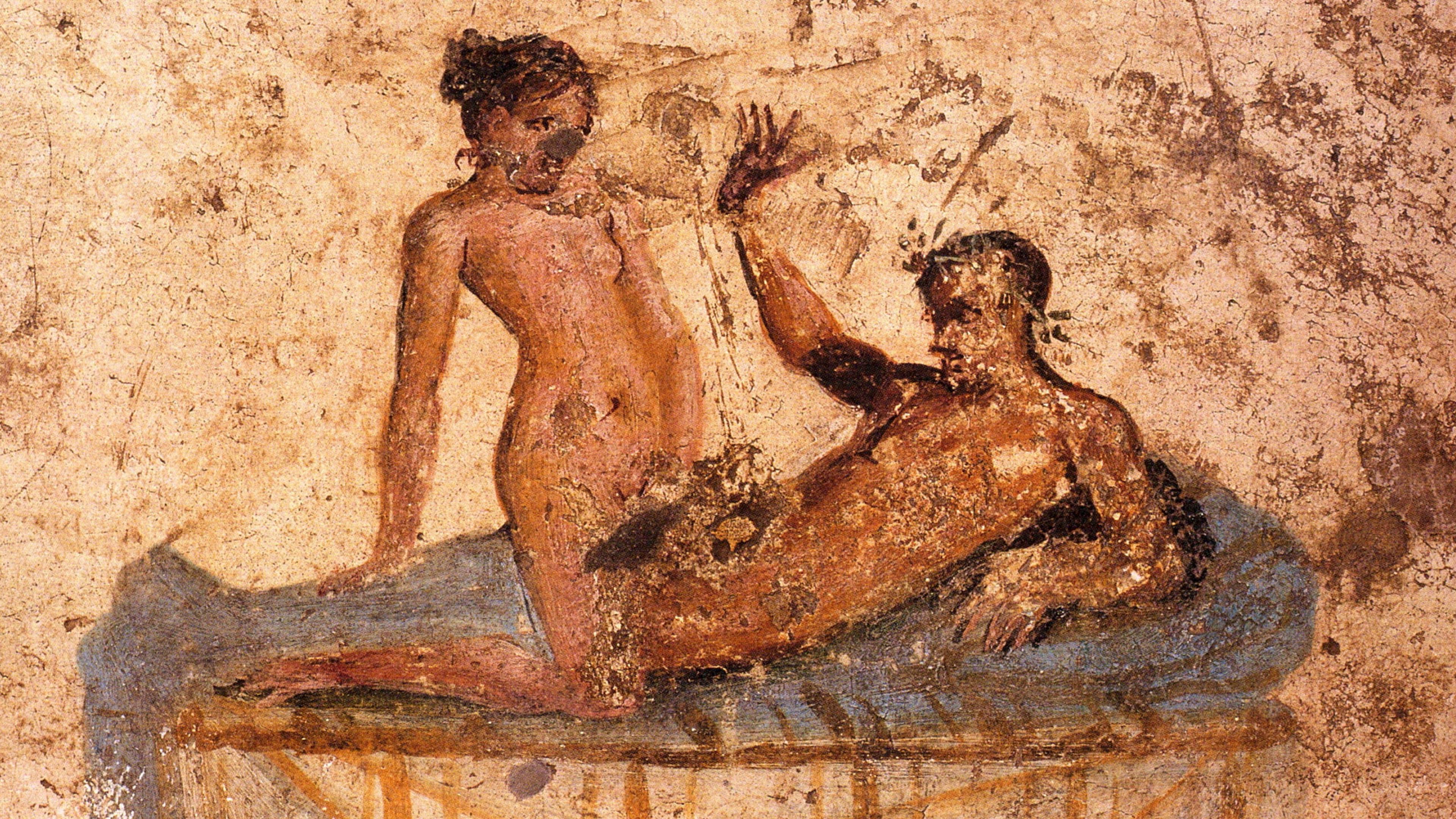 Ancient Roman fresco depicting a nude couple in an intimate pose on a bed, with faded hues on a textured background.
