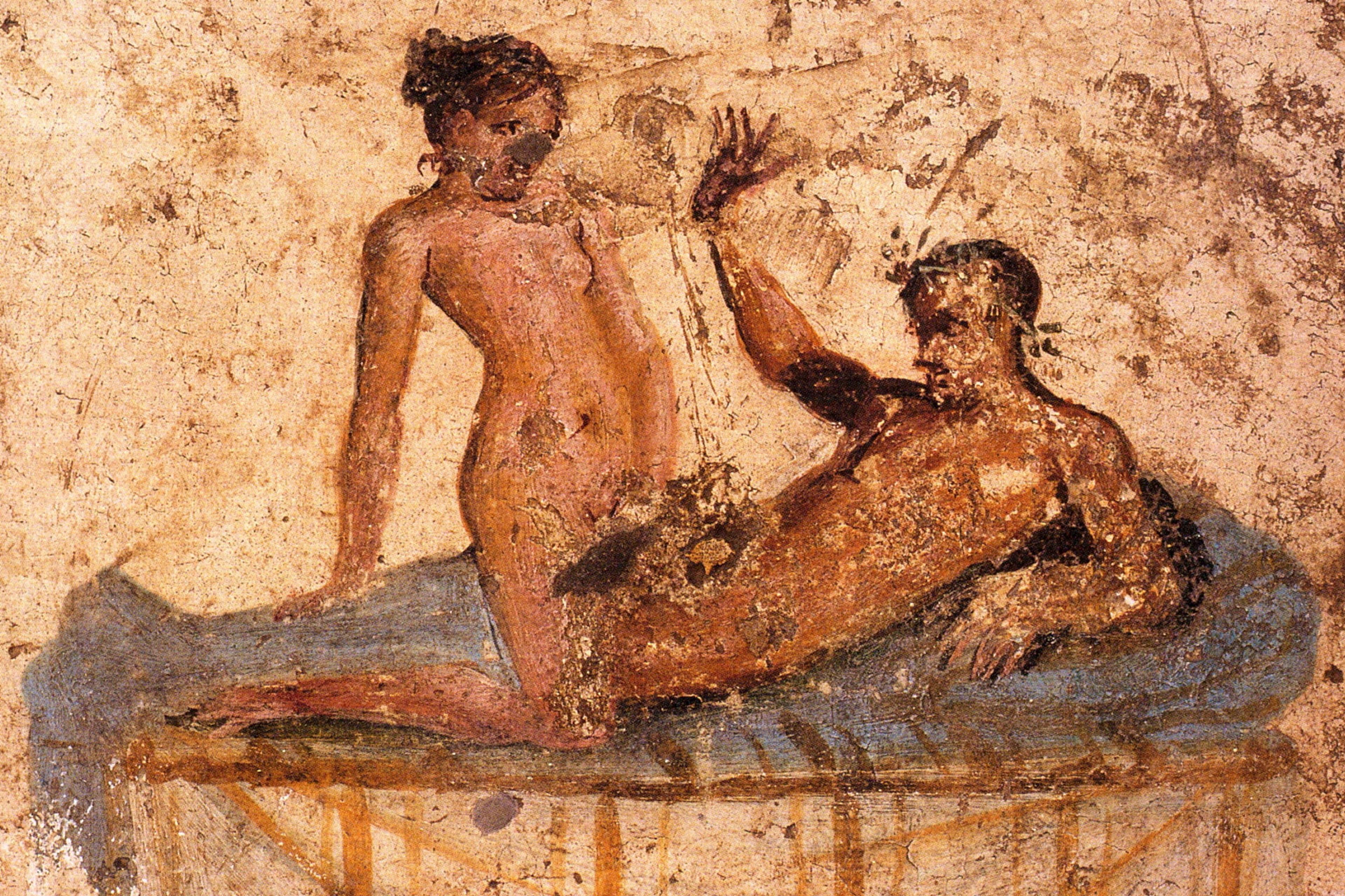 Ancient Roman fresco depicting a nude couple in an intimate pose on a bed, with faded hues on a textured background.