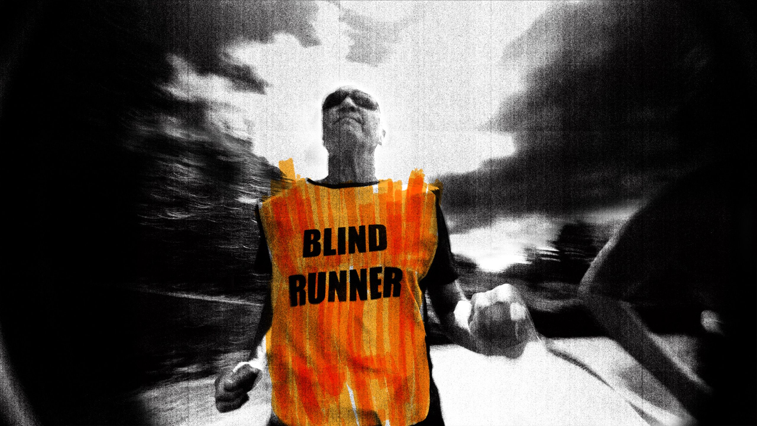 Black-and-white photo of a person running wearing an orange vest reading ‘Blind Runner’ with blurred background.