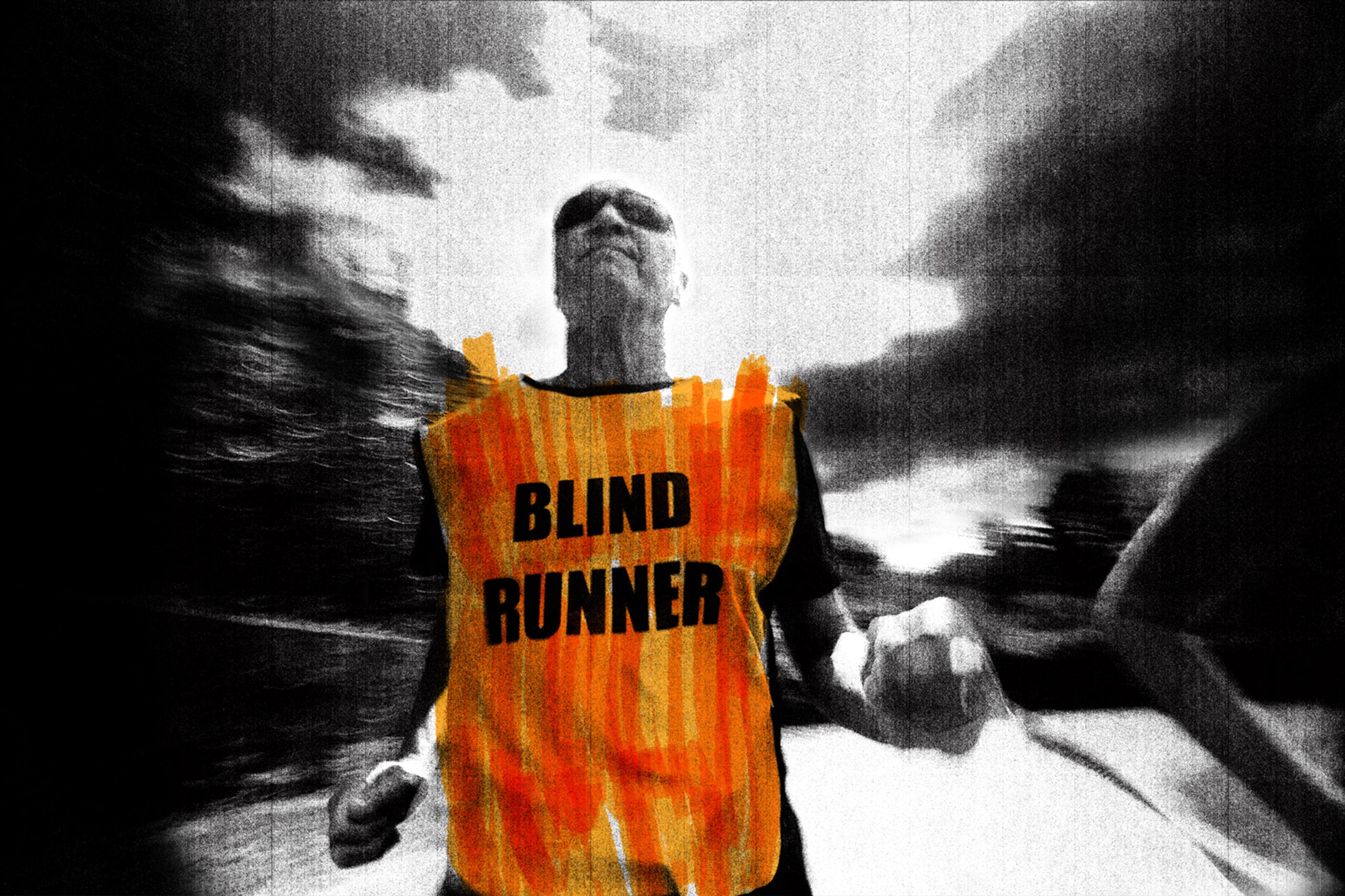 Black-and-white photo of a person running wearing an orange vest reading ‘Blind Runner’ with blurred background.