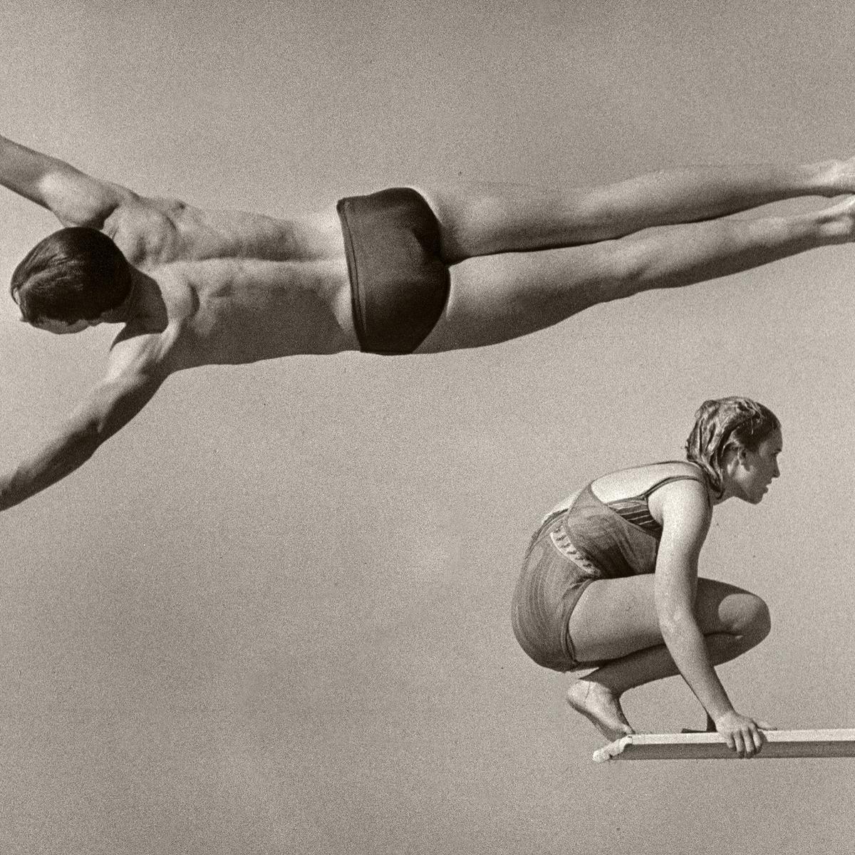 Swimmers diving off a diving board