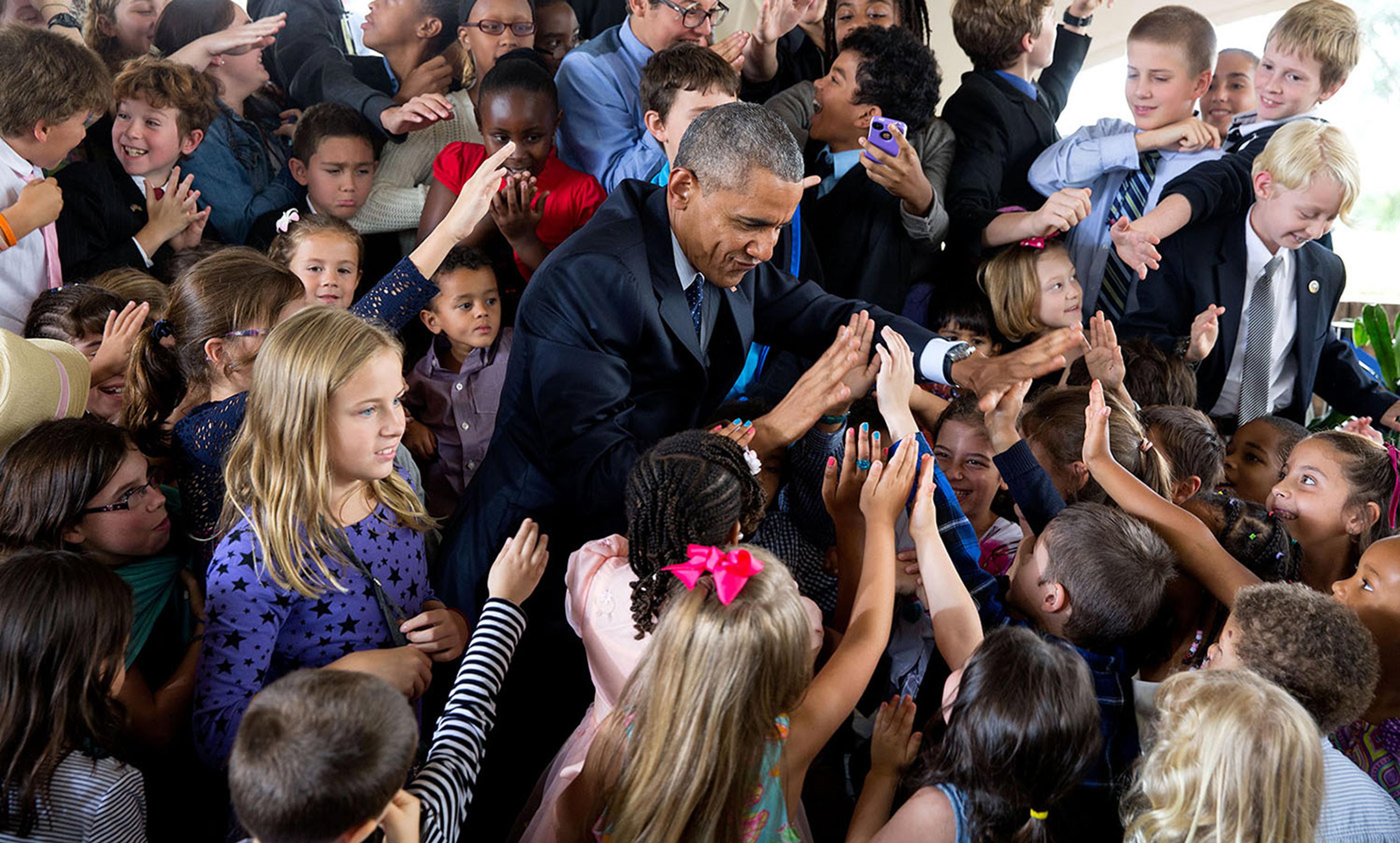 <p>Former President Obama greets children at the US Embassy in Nairobi, Kenya in 2015. <em>Official White House photo by Pete Souza</em></p>
