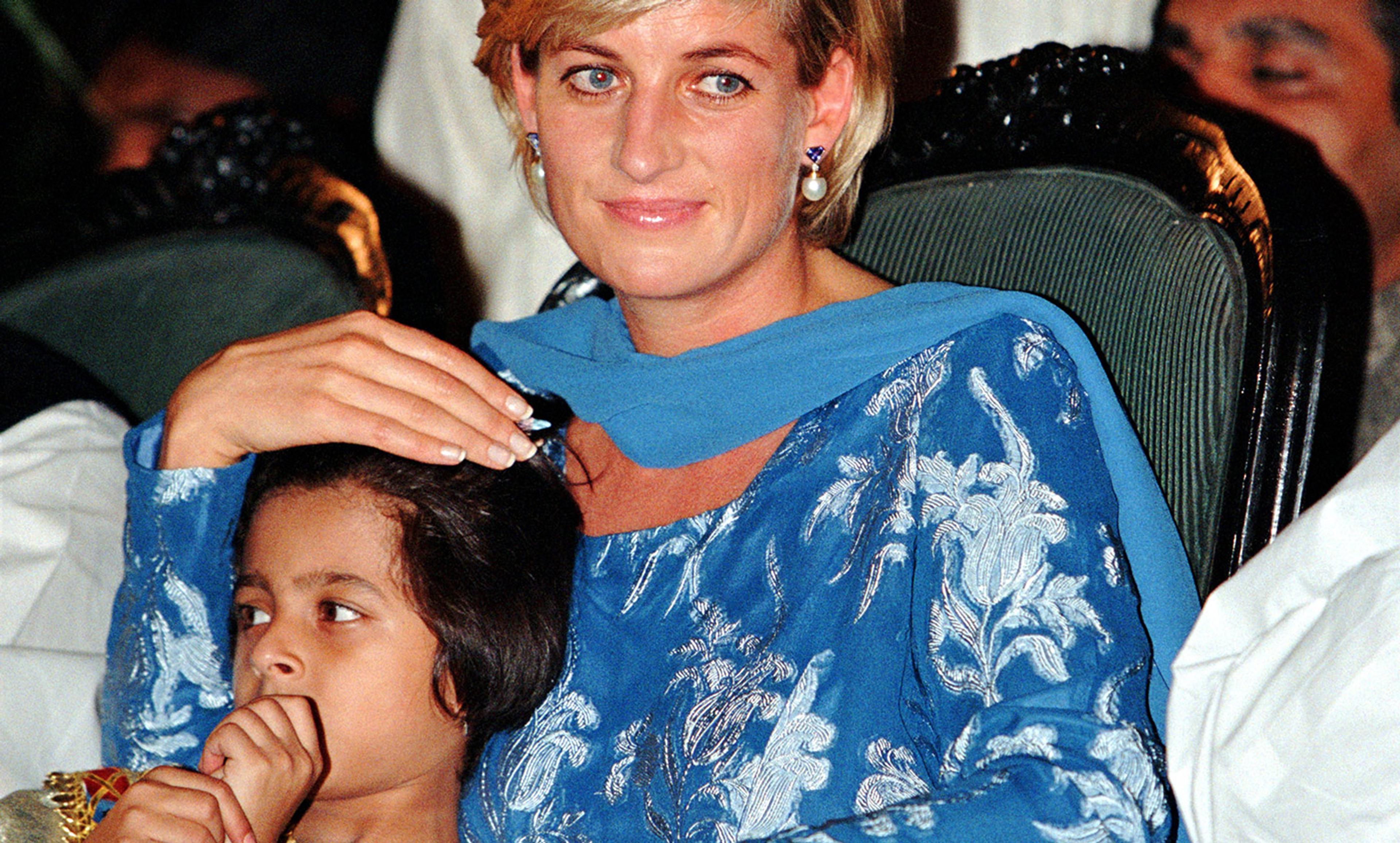 <p>The royal touch; Princess Diana with a young cancer patient in Lahore, Pakistan, May 1997. <em>Photo by Rex Features</em></p>