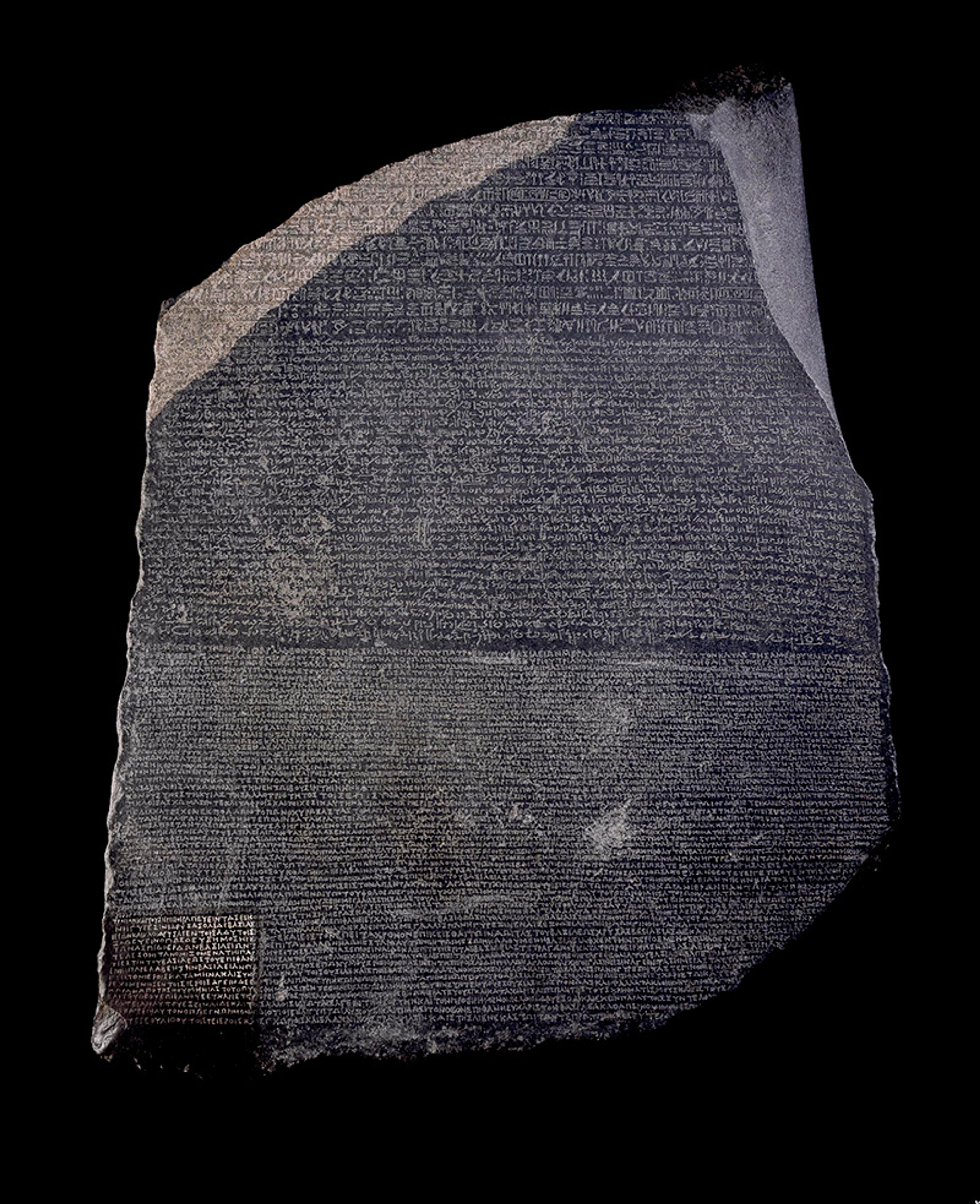 Photo of the Rosetta Stone featuring ancient inscriptions in three scripts on a dark stone background.