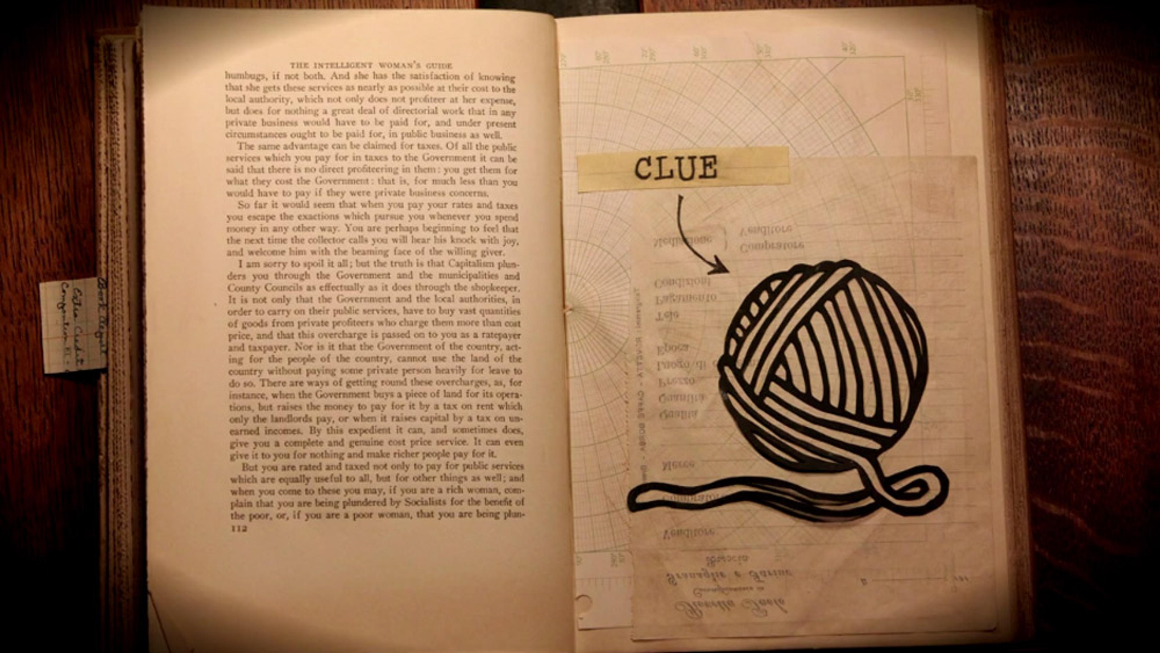 An open book. Left page has text while the right page shows a drawn ball of yarn next to a label reading “CLUE”.