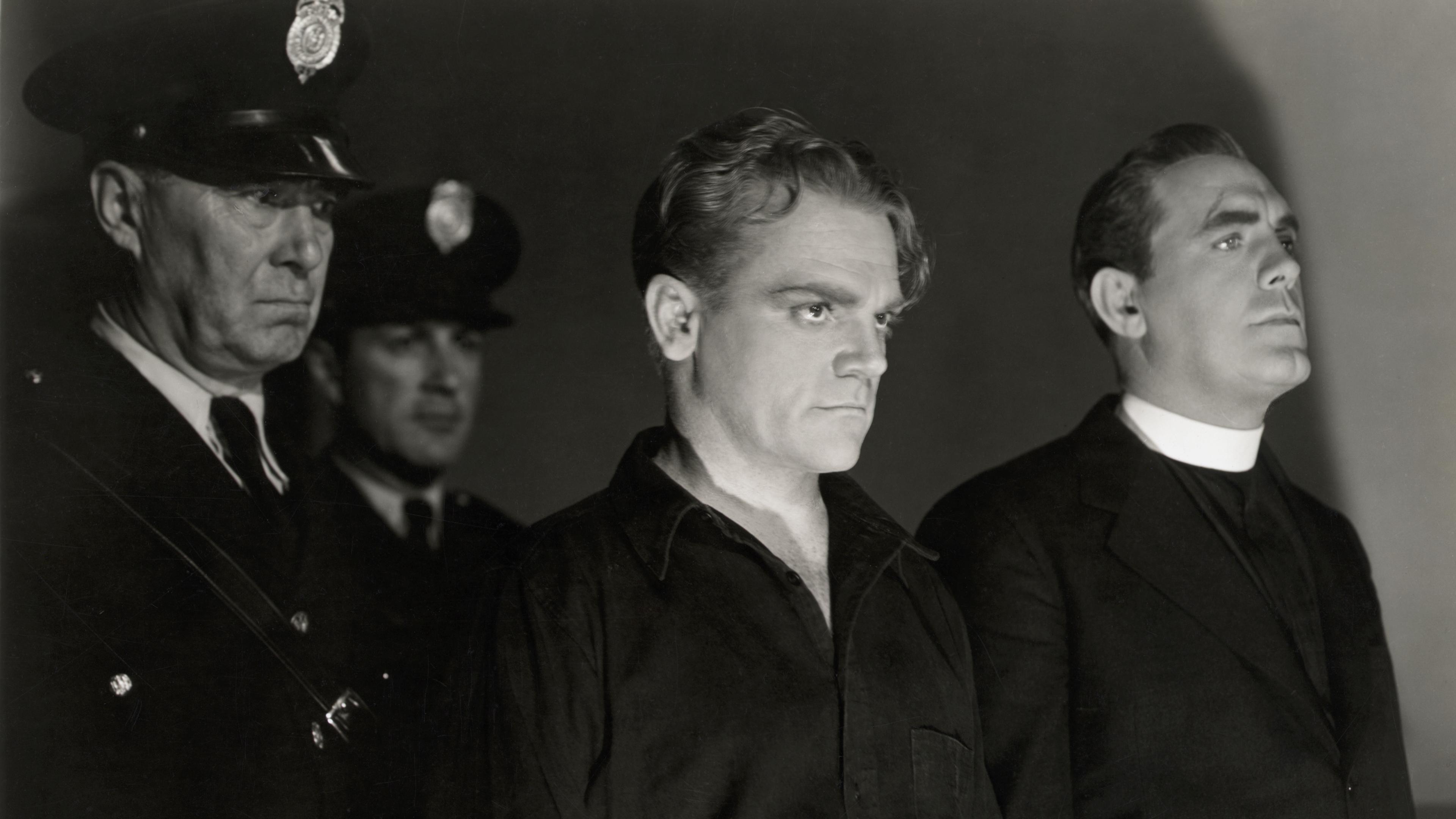 Black and white photo of two policemen, a man in dark clothing, and a priest standing in a dimly lit setting.