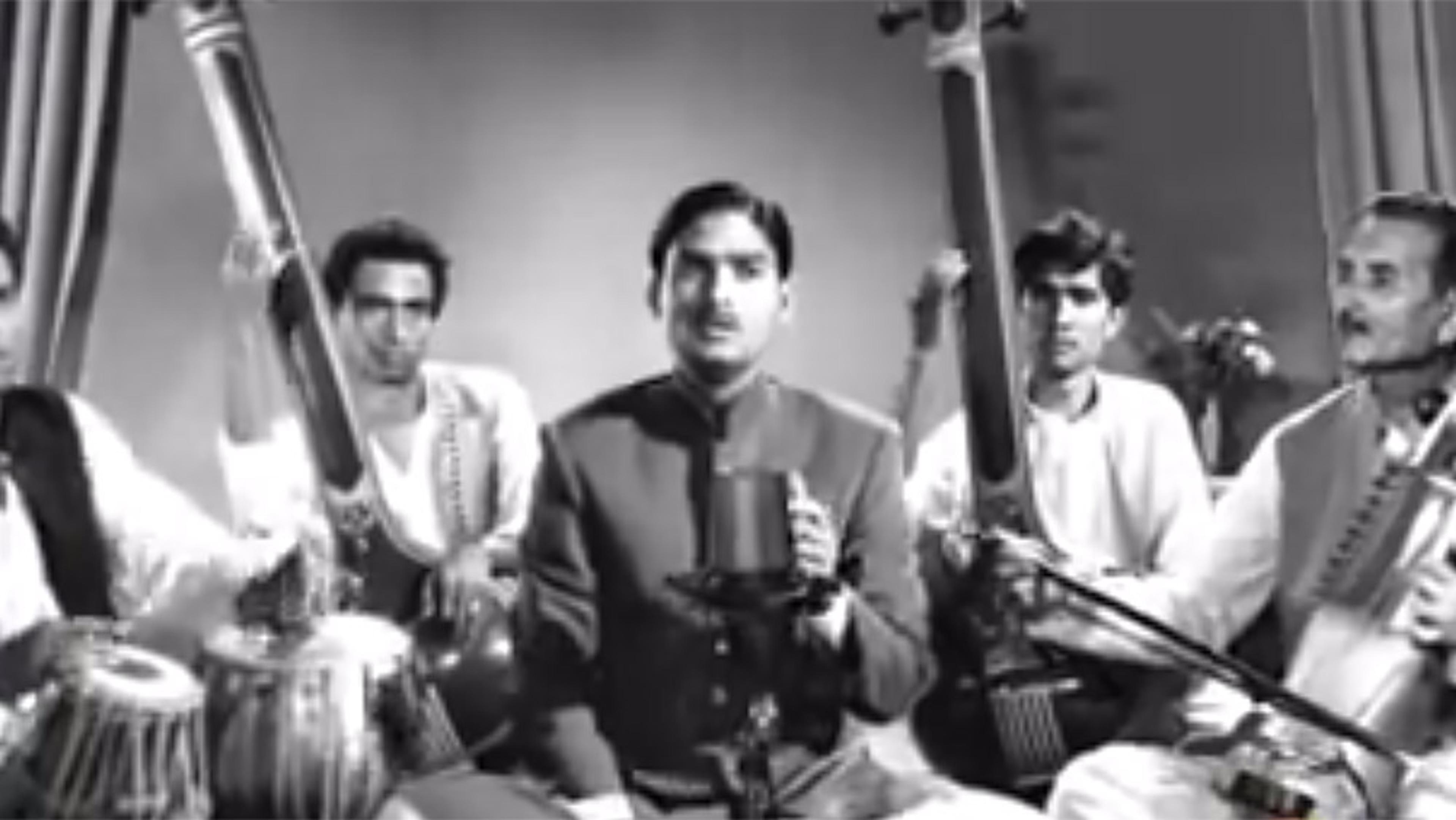 Vintage photo of five musicians sitting with their instruments, singing and playing traditional Indian classical music.