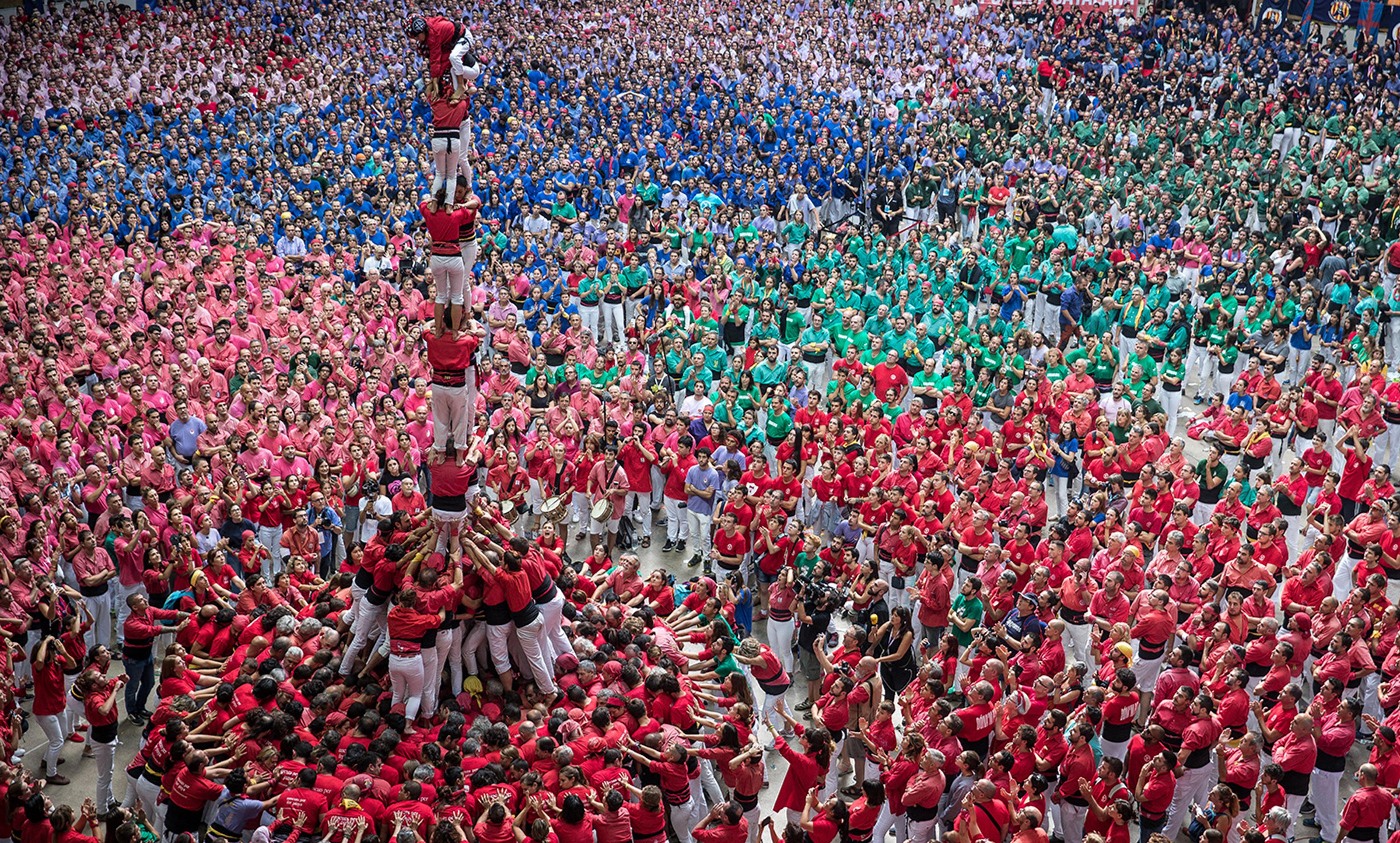 <p>Members of the Castellers de Barcelona build a human tower in Tarragona, Spain, October 2007. <em>Photo by Maja Hitij/Getty </em></p>