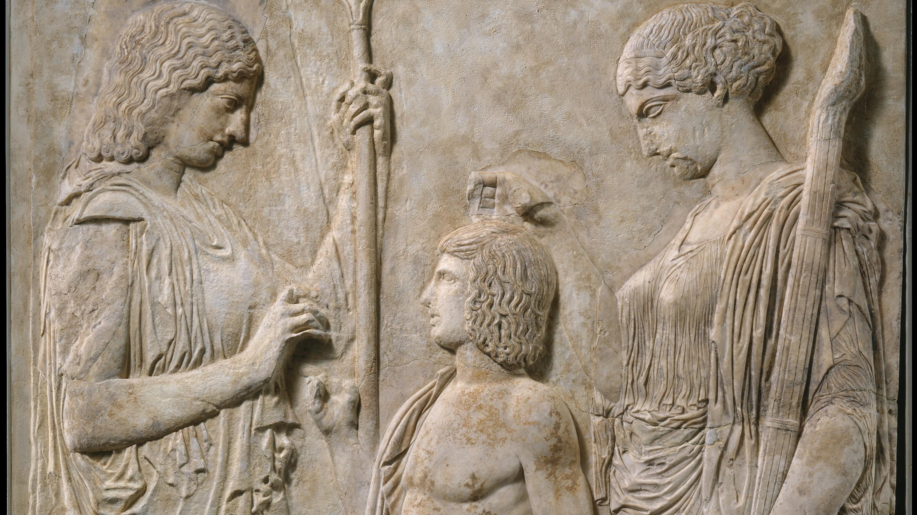 Ancient Greek marble relief showing three figures in a carved scene.