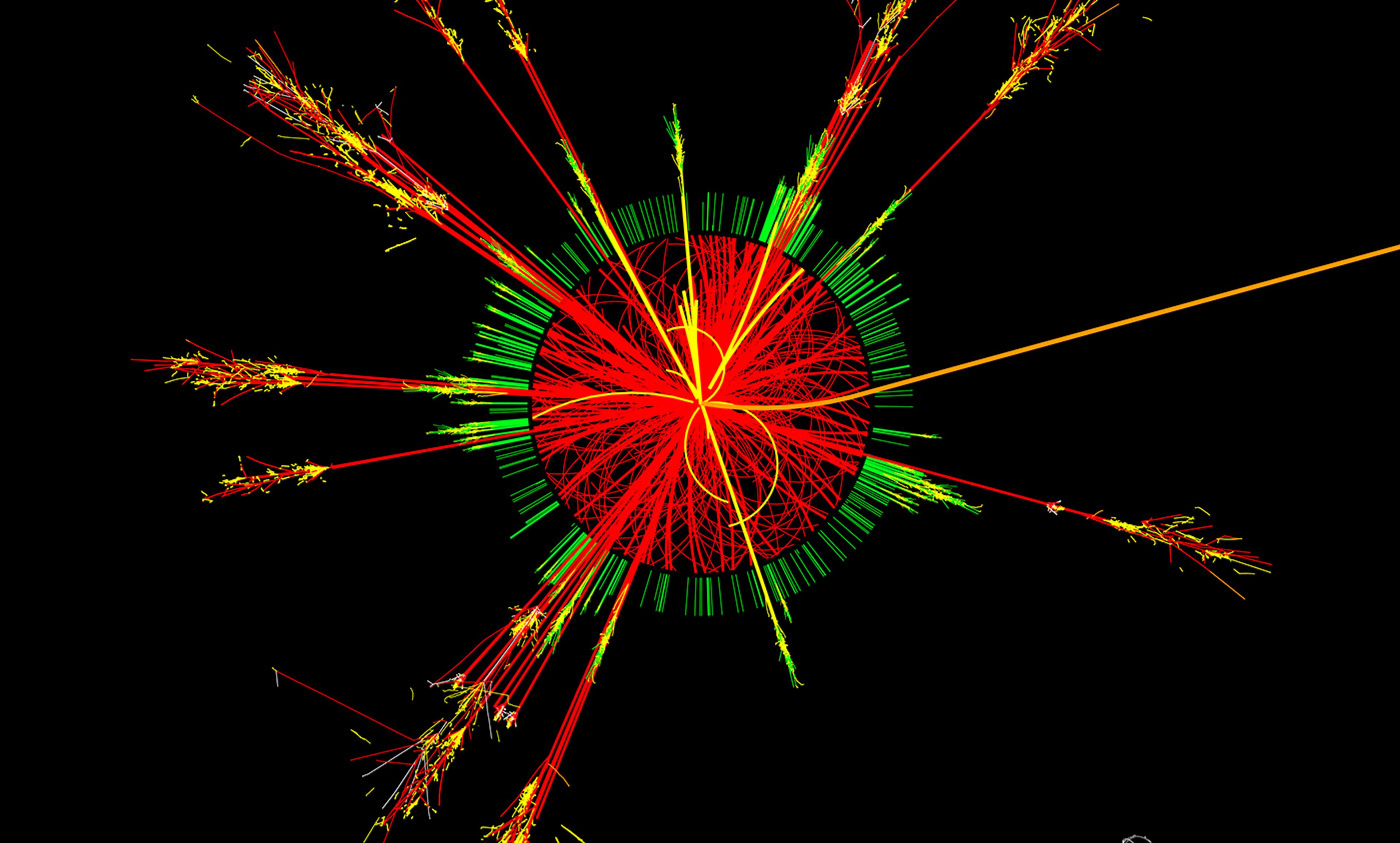 Computer-generated image of particle collision data, showing vibrant red, green and yellow tracks radiating from a central point.