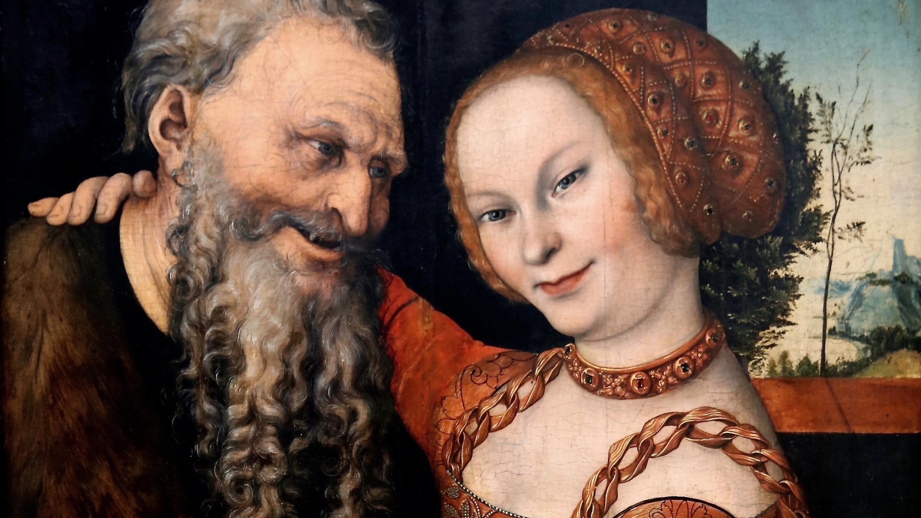 Painting of an elderly man with a beard and a young woman in a red dress, both in a warm embrace with a landscape backdrop.