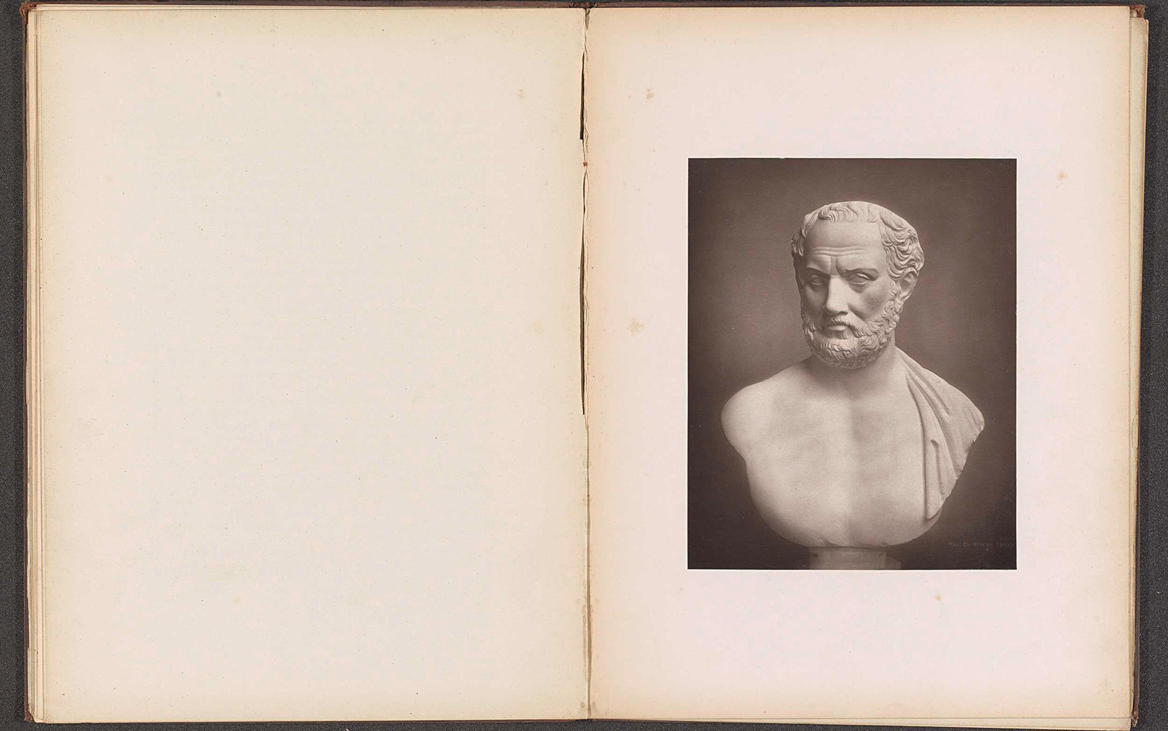 A marble bust of Thucydides is shown on a page from an old book. The opposite page is blank.
