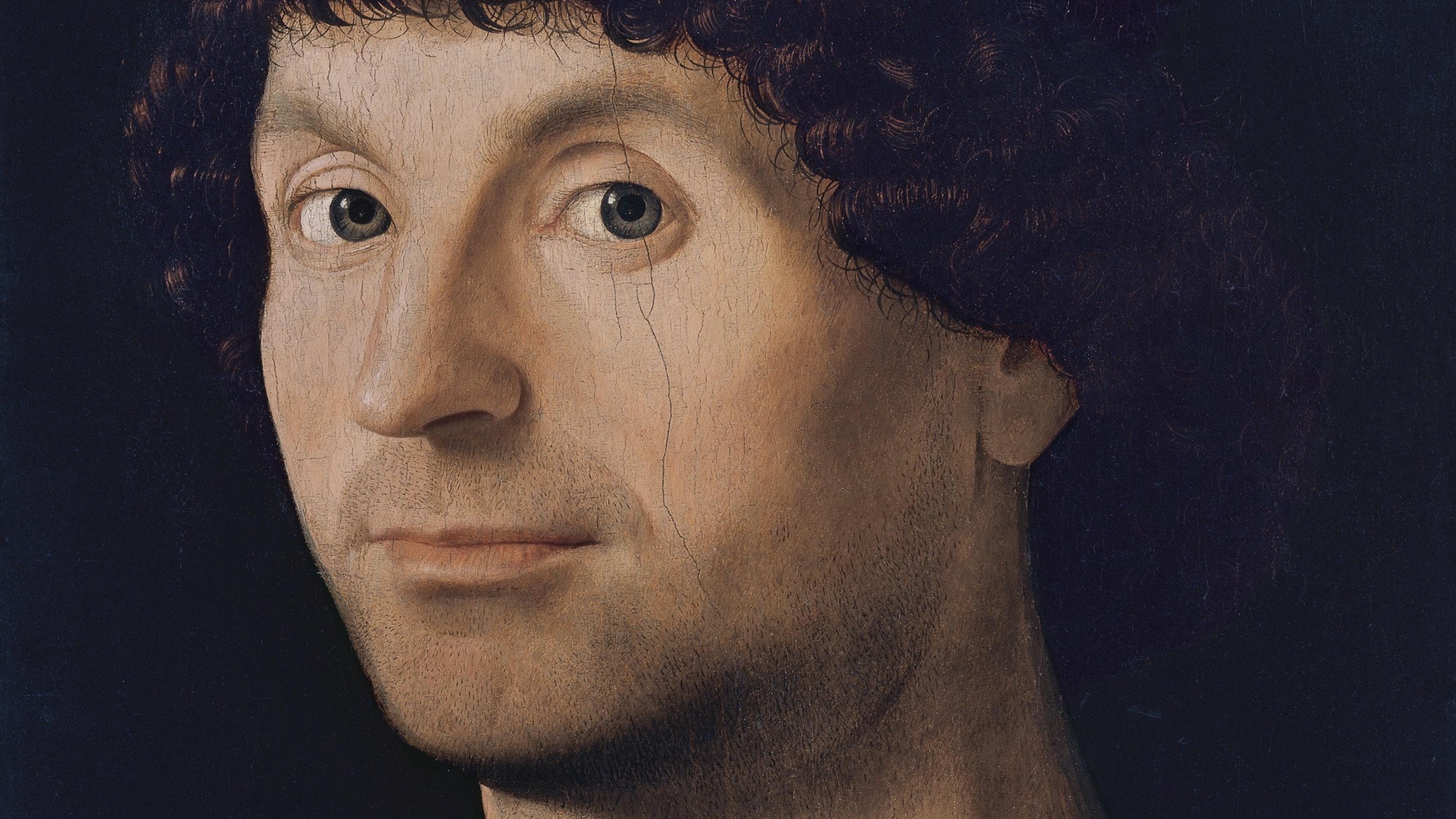 Renaissance painting of a man with curly hair wearing a dark hat and clothing against a dark background.