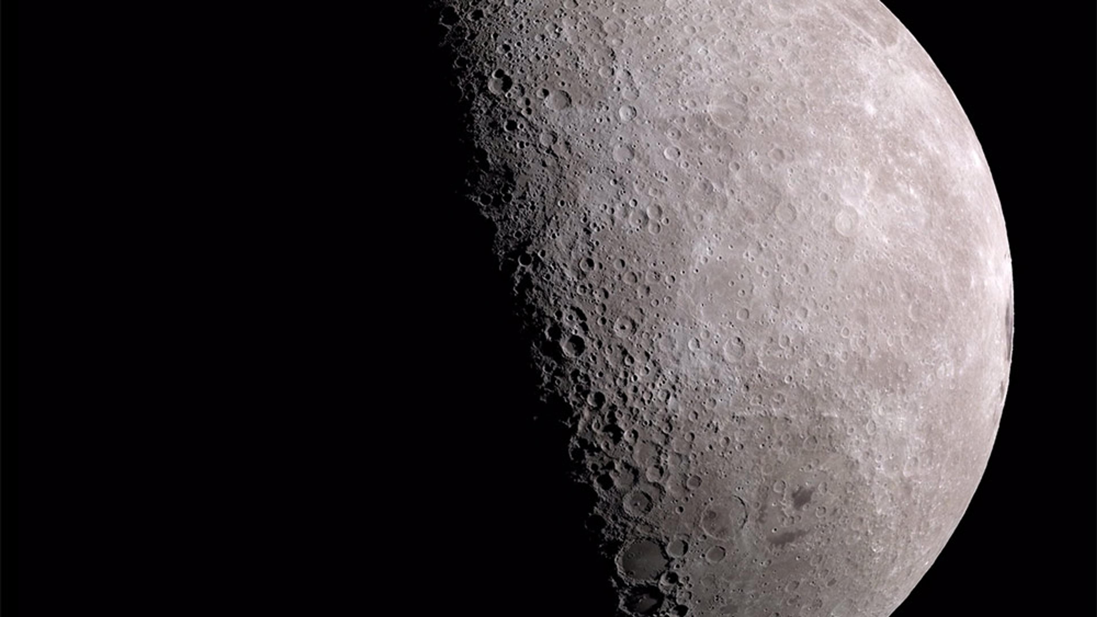 The Moon’s surface showing its craters and the transition between the illuminated and dark sides against a black space background.