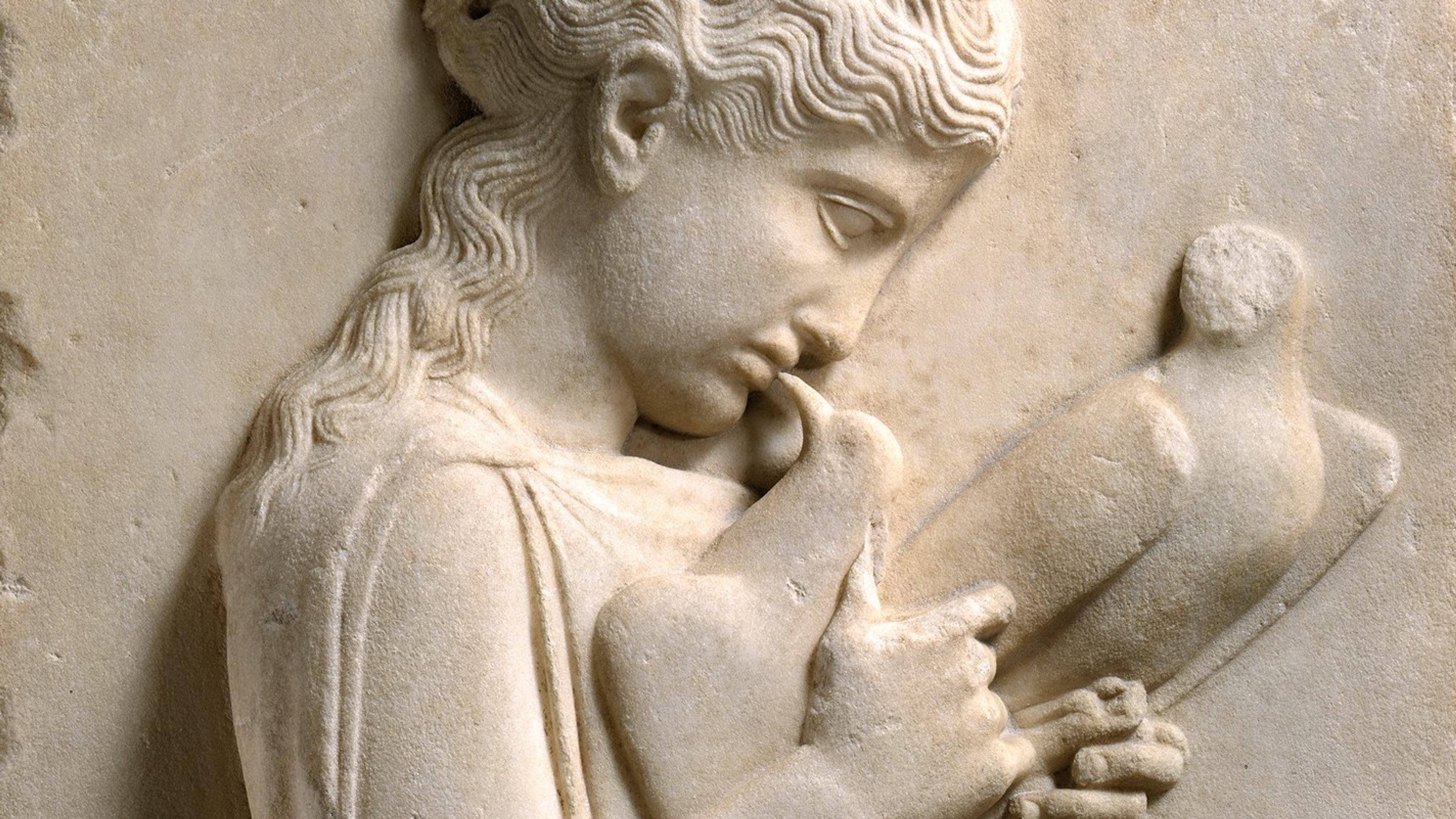 Ancient Greek marble relief of a girl holding doves, displayed on a pedestal, depicting detailed clothing and serene expression.